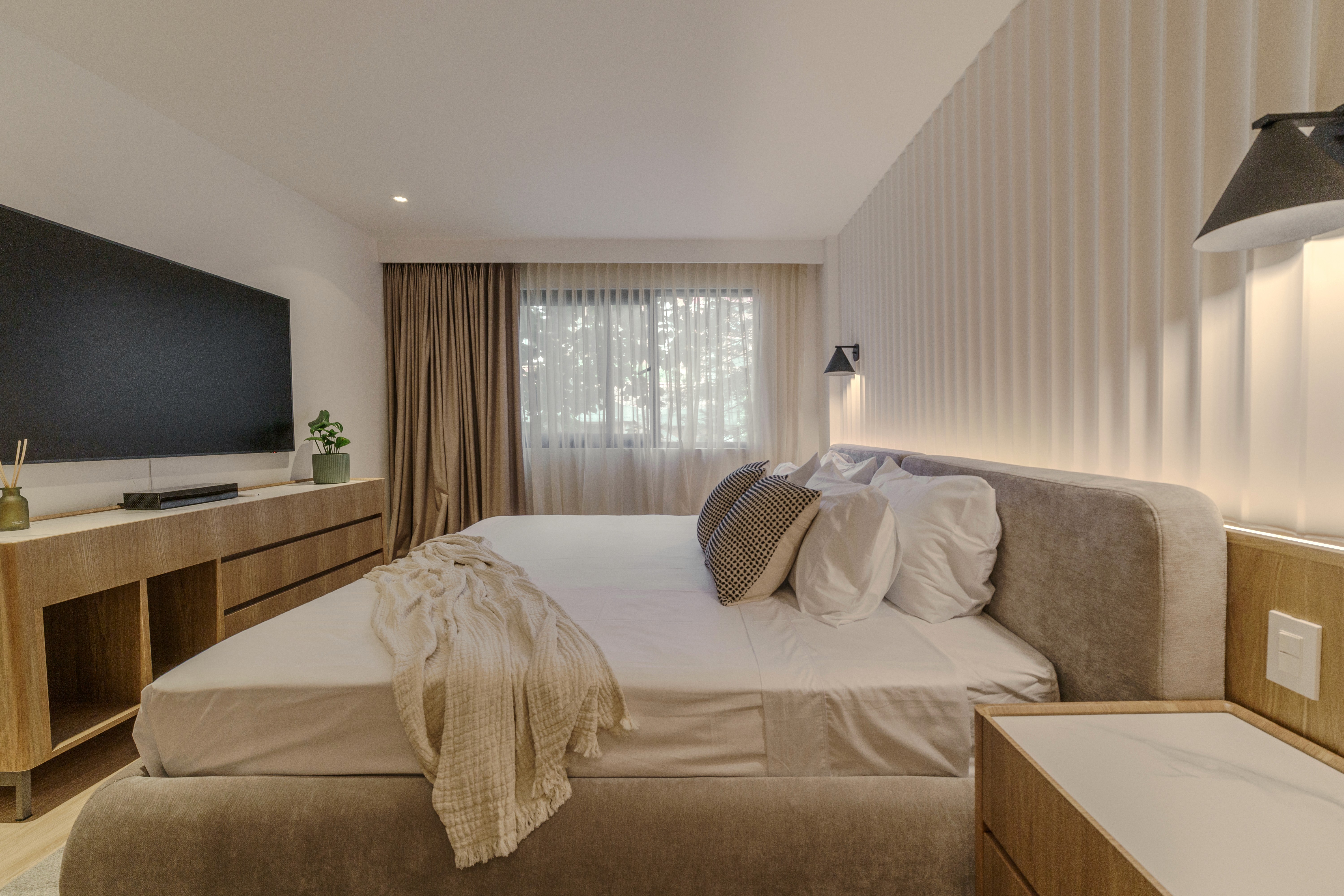 Double-height interior with flowing sculptural forms and warm raking light