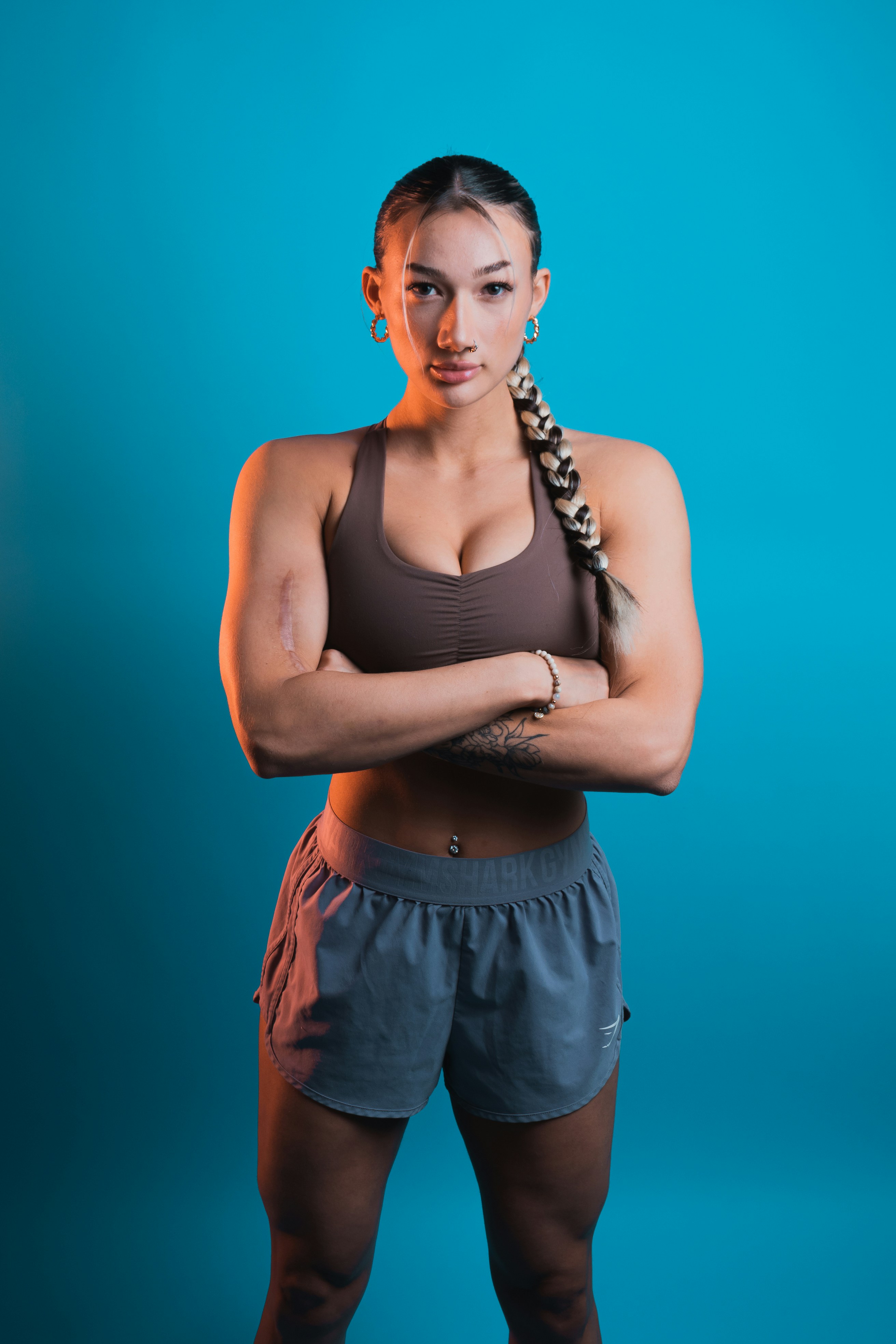 a woman with her arms crossed posing for a picture