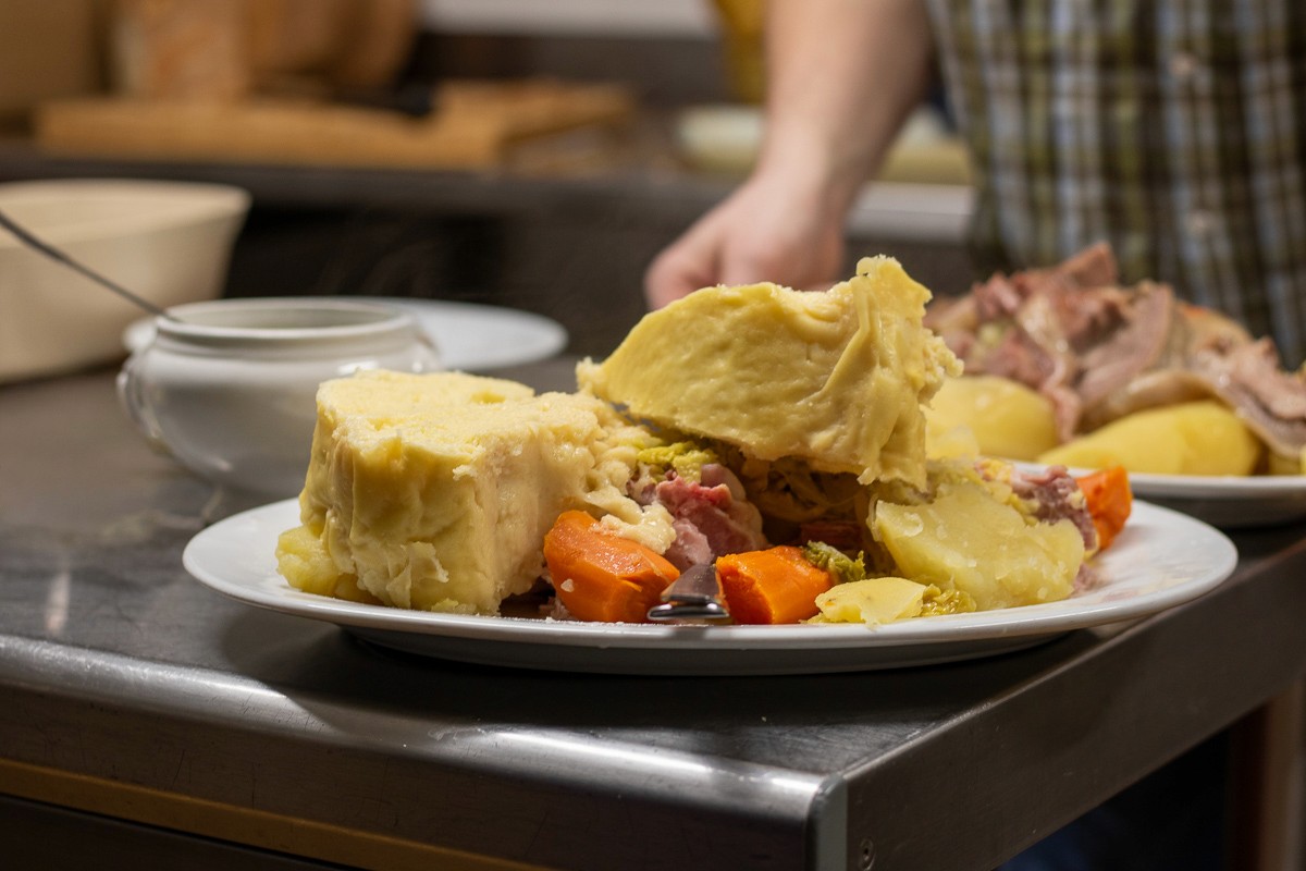 person slicing vegetable