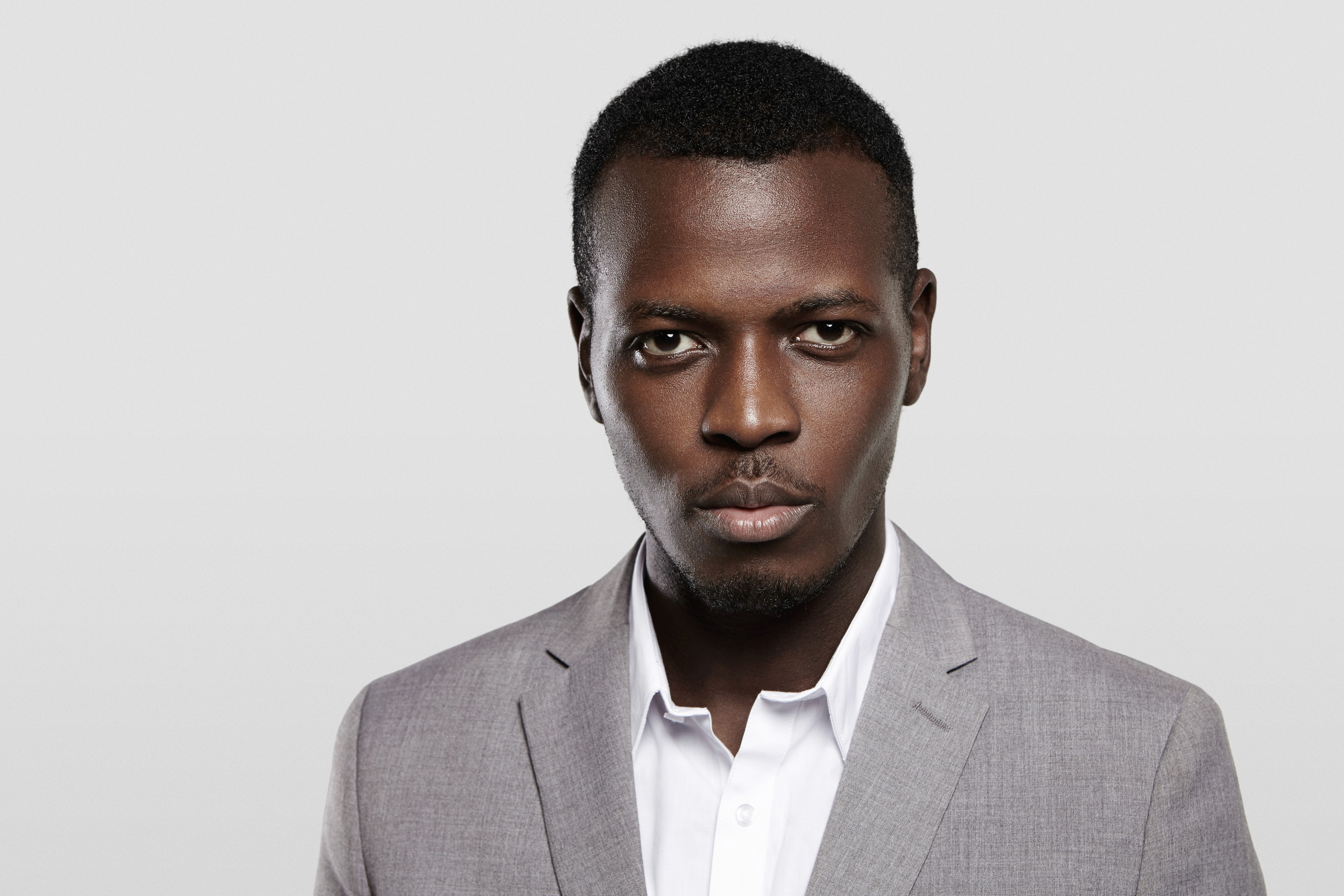 man stranding on straight road photo during daytime