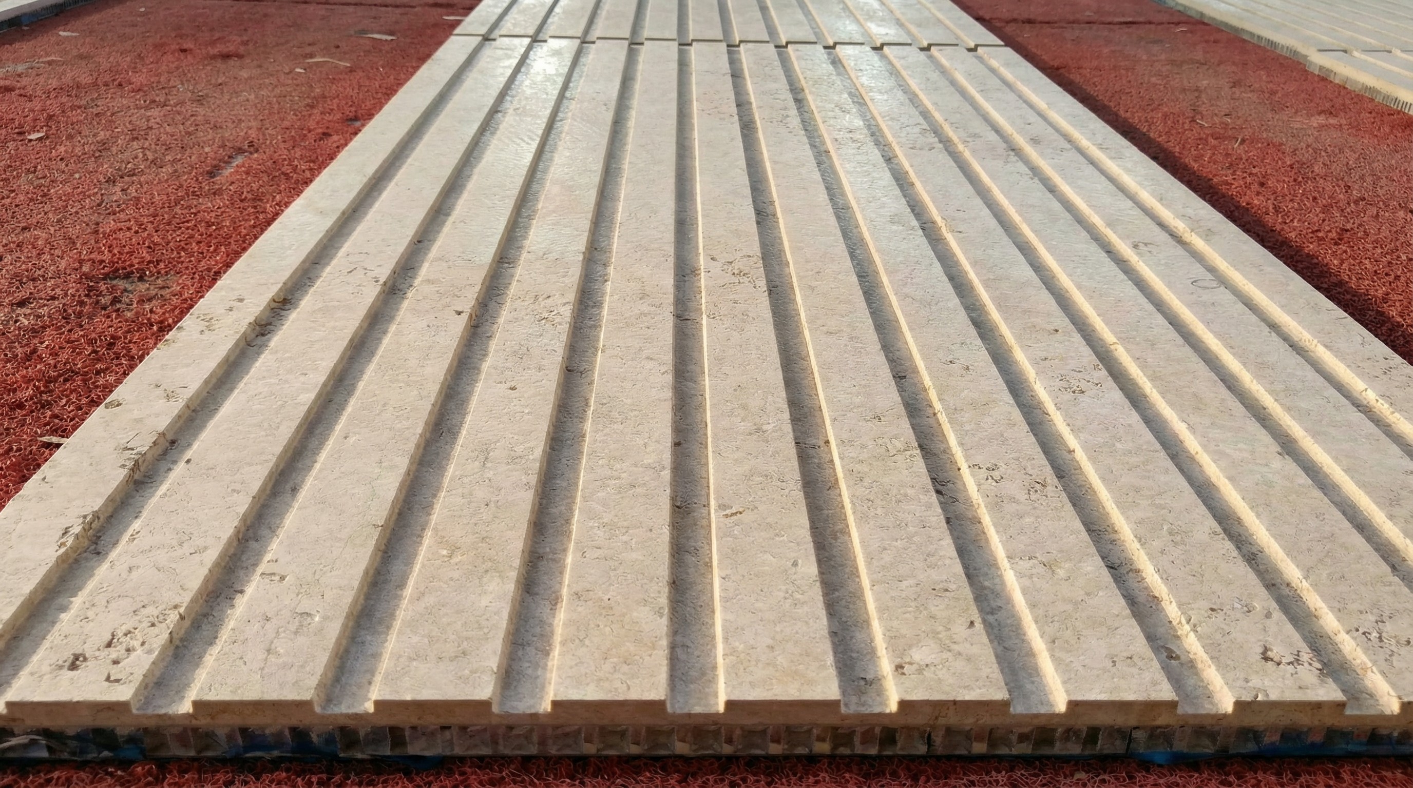 Close-up of lightweight limestone honeycomb composite panel with grooved texture by NOVA STONE.