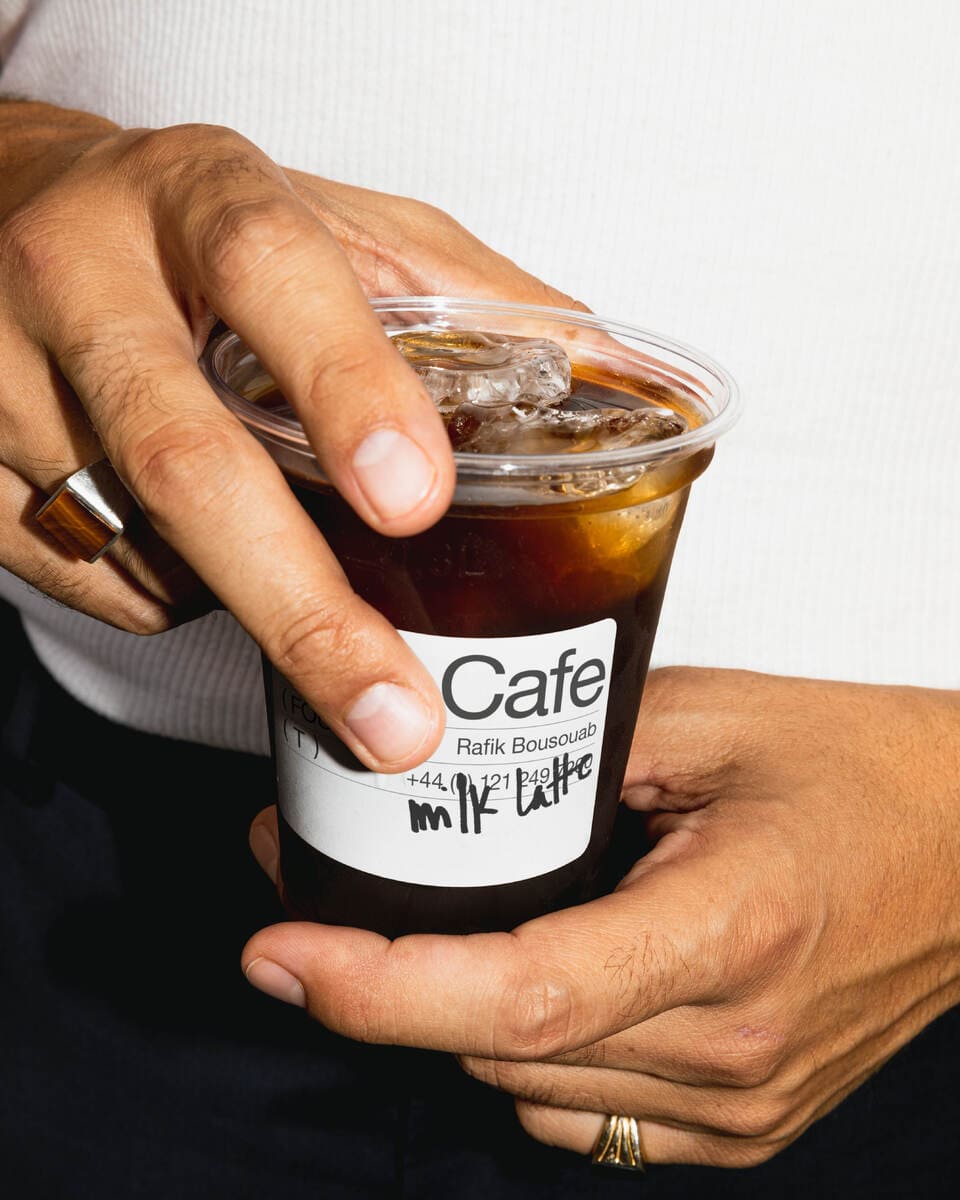 Close-up of a cup of coffe with the product label designed.