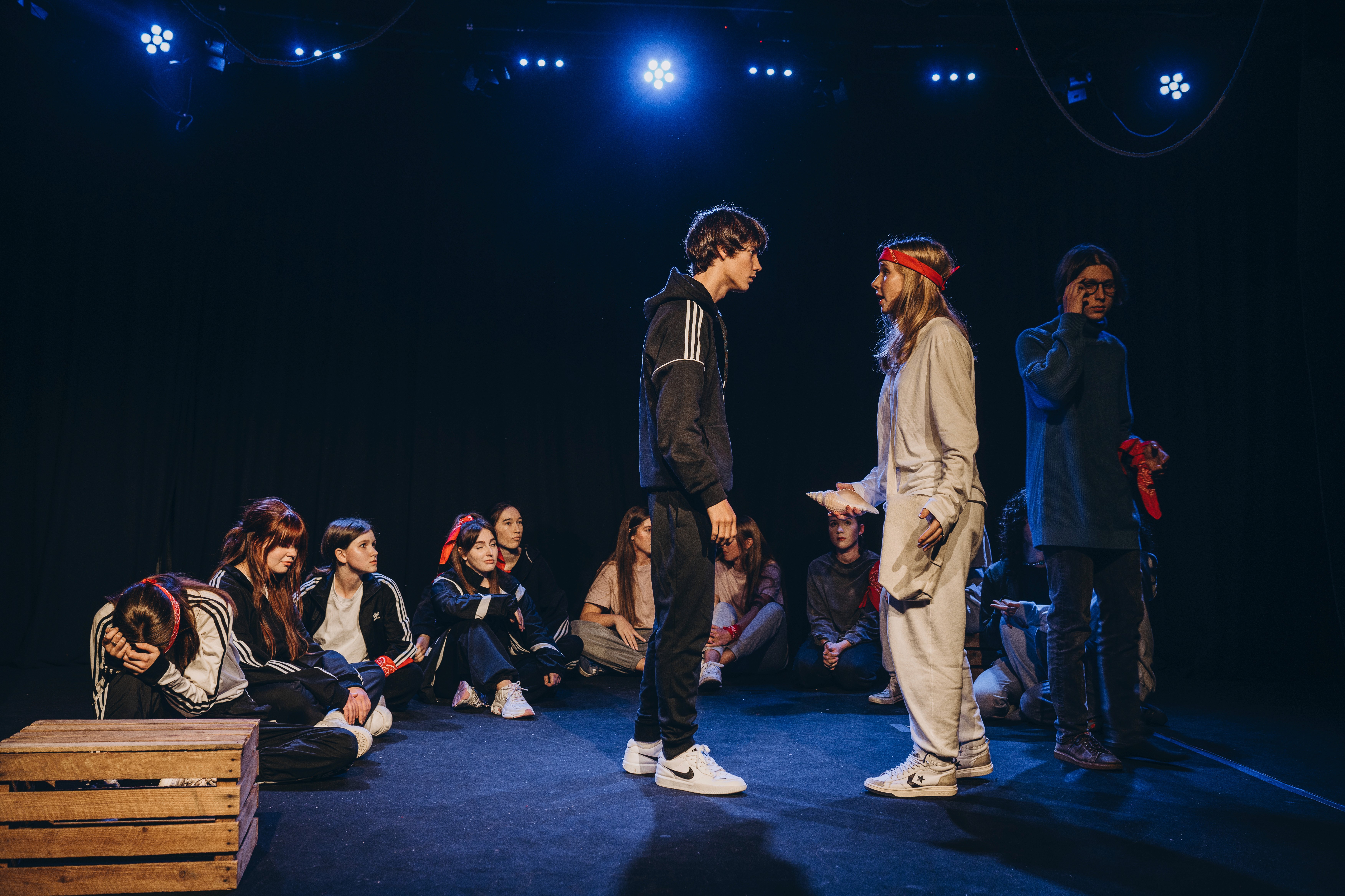 Foto von jungen Leuten, die das Theaterstück aufführen.