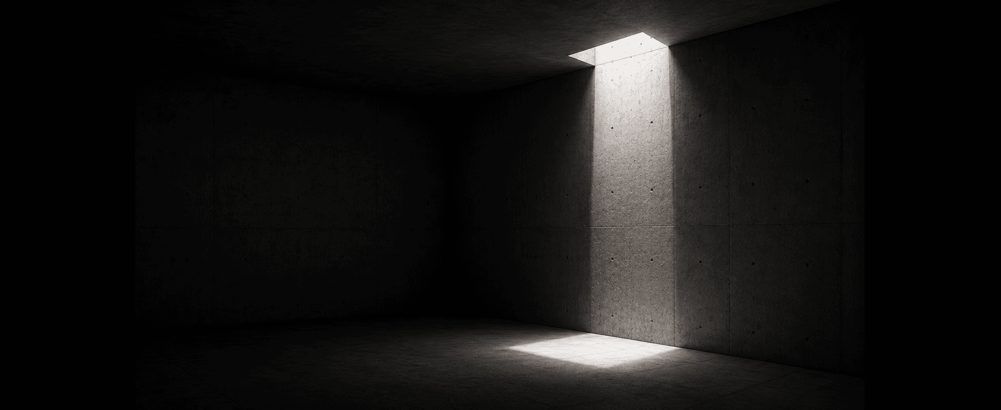 Minimalist concrete interior illuminated by a single shaft of light, representing the identification of underlying organisational and operational issues.
