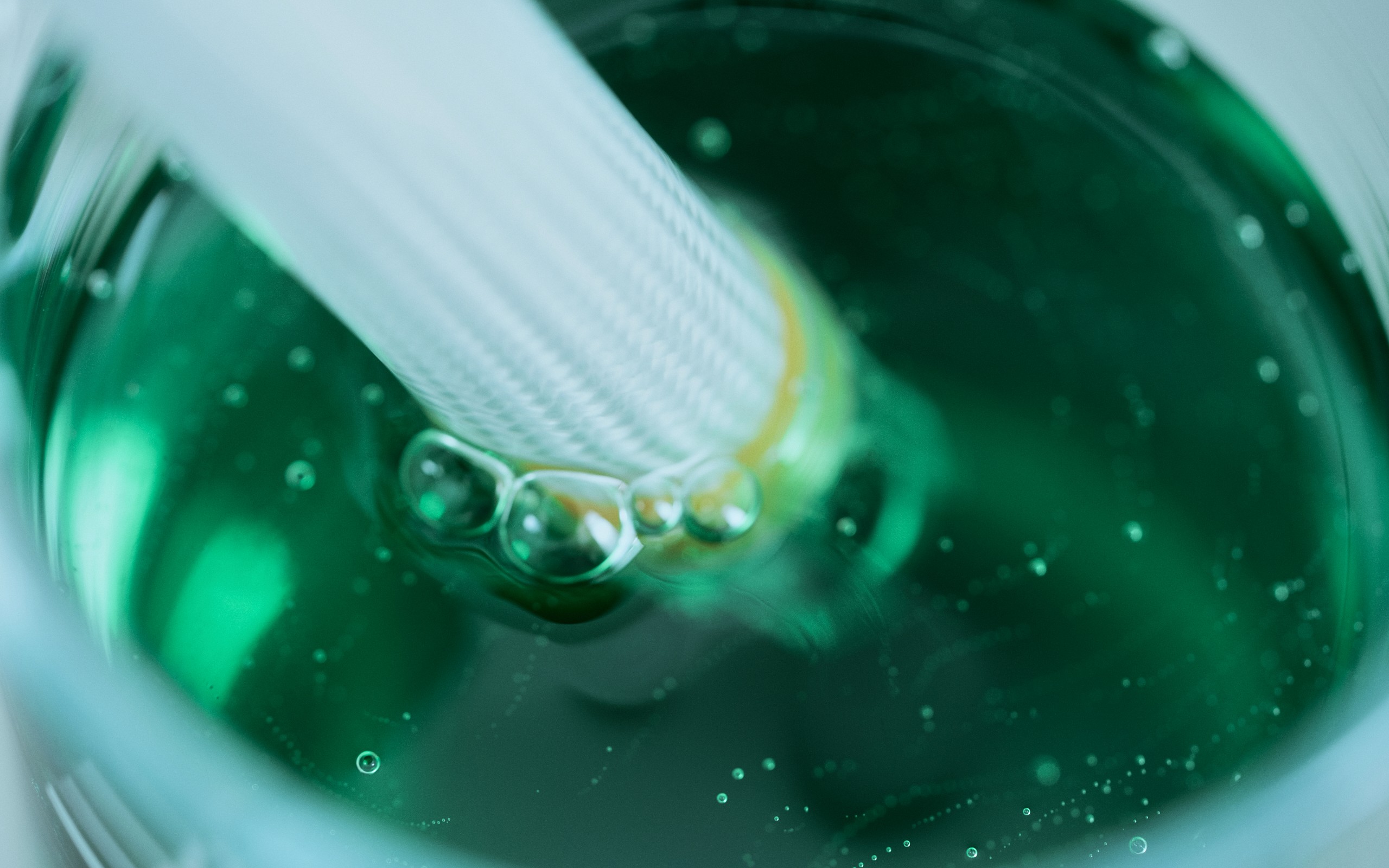 Greenleaf Cosmetics | Green tube going into liquid
