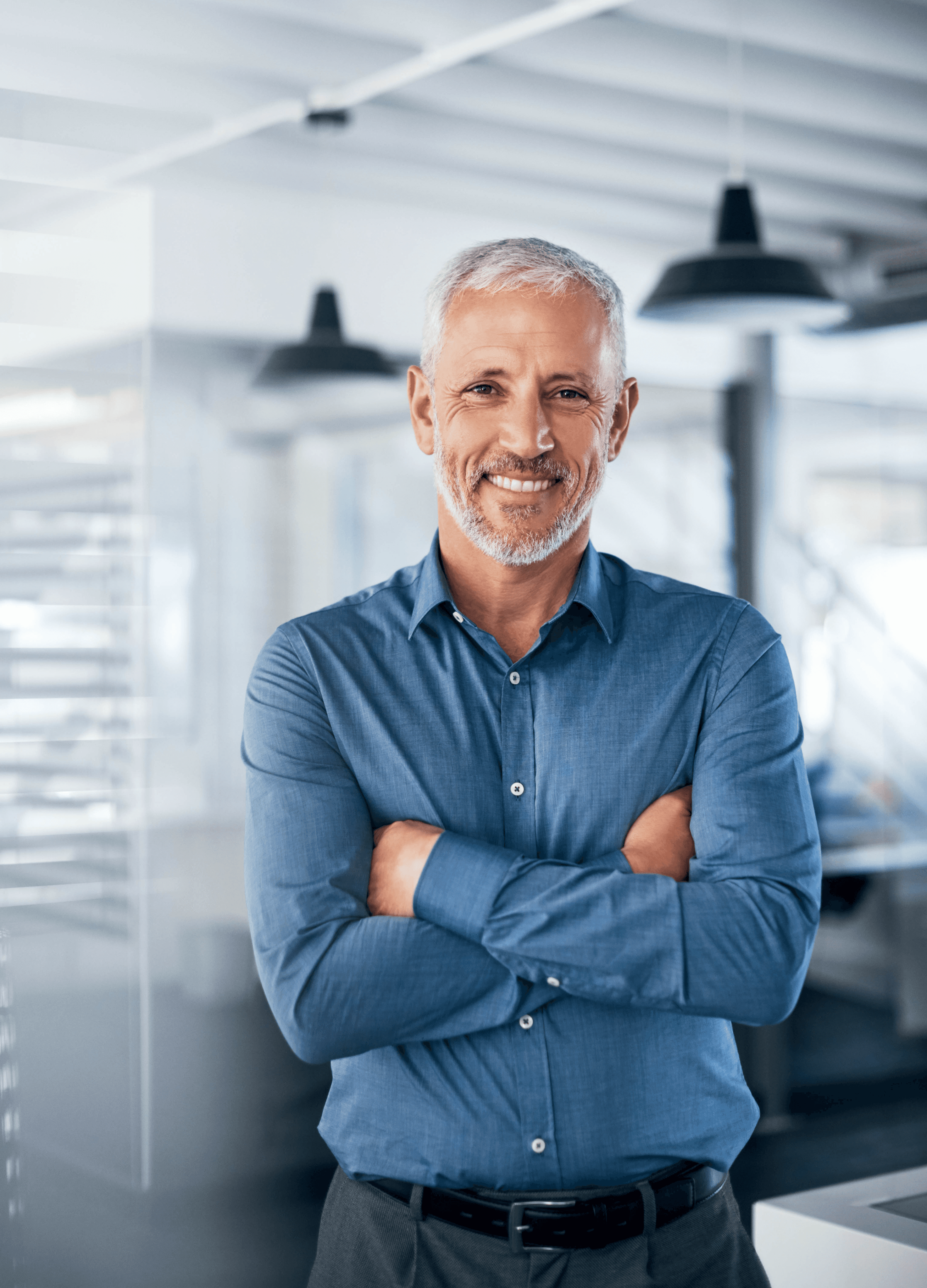 middle-aged male exec in a blue shirt, arms crossed, office setting