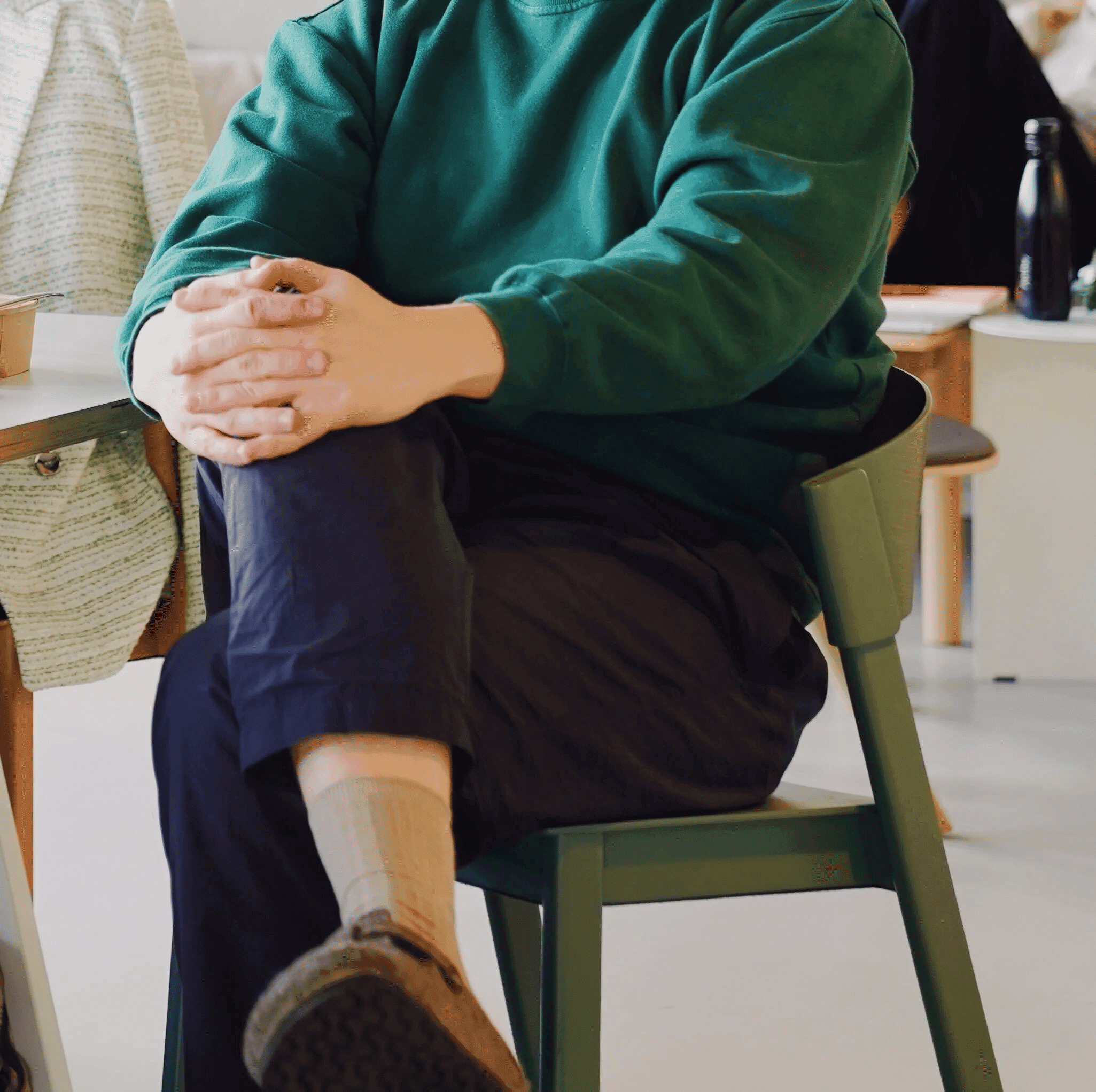 Person sitting in chair in coworking environment for recruiters showing workspace culture