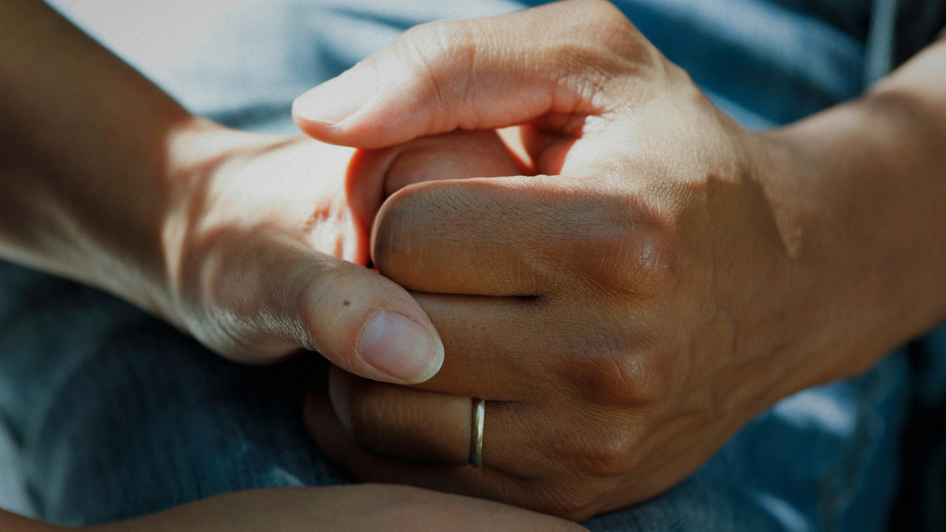 grayscale photo of man and woman holding their hands