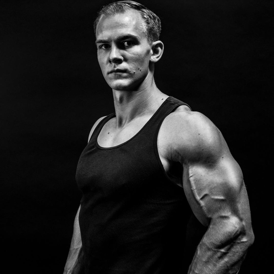woman wearing red long-sleeved shirt beside wall