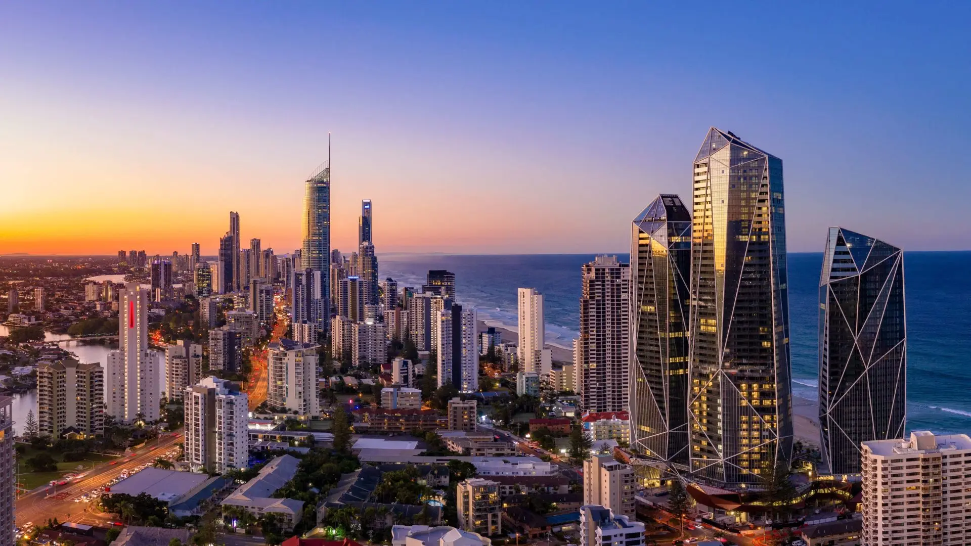 City skyline and ocean at sunset.