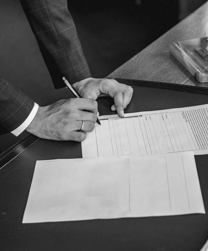 Person locking the front door of a home, representing property transfer and conveyancing services.
