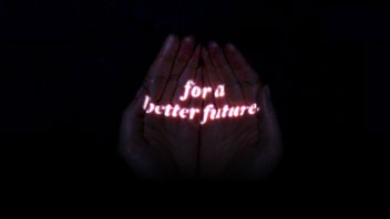 Two hands are raised against a black background. Red text reading "for a better future" is centered on the palms. The hands are positioned palms-up with fingers slightly spread apart.