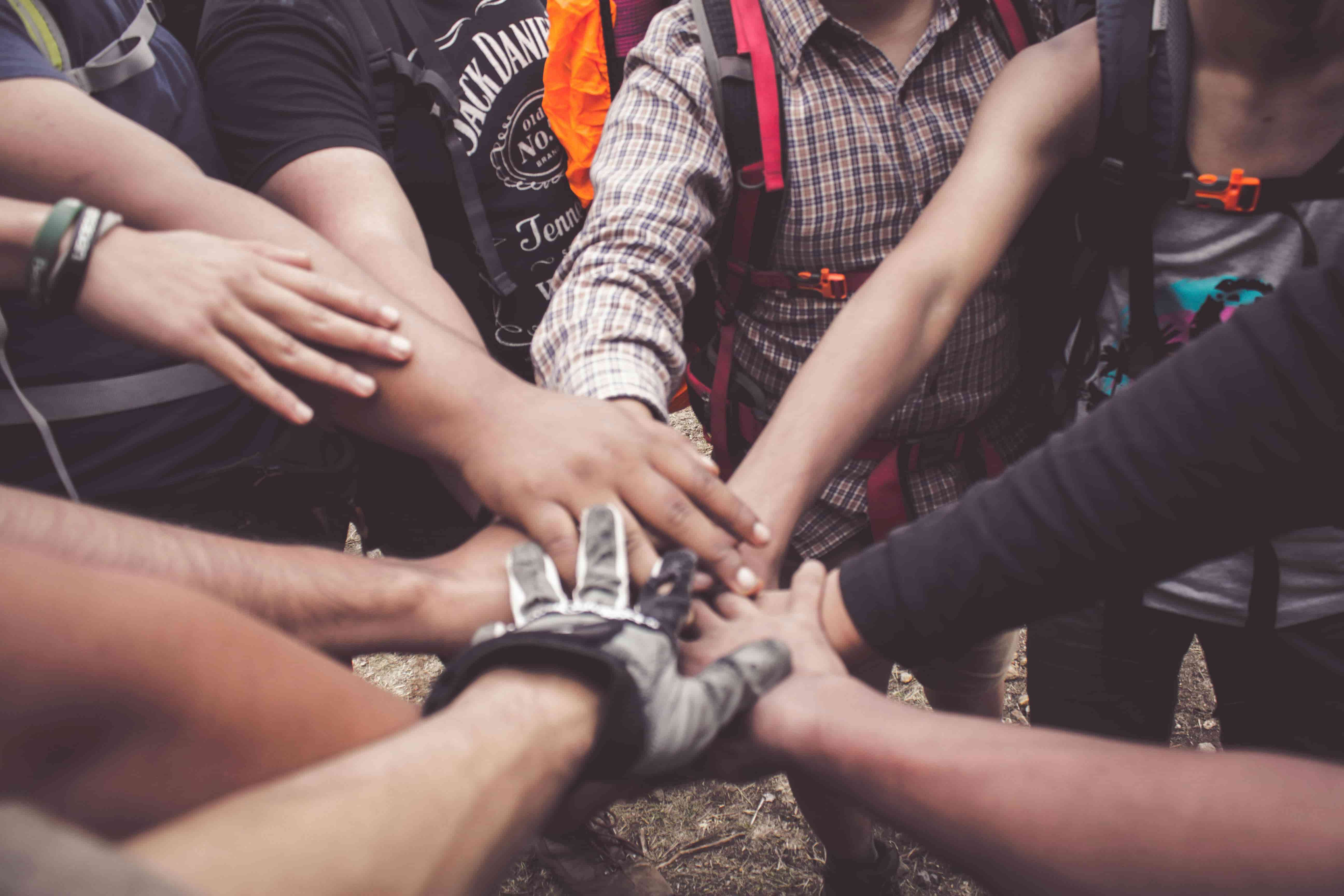 An image of hands coming together to show our team's ethic