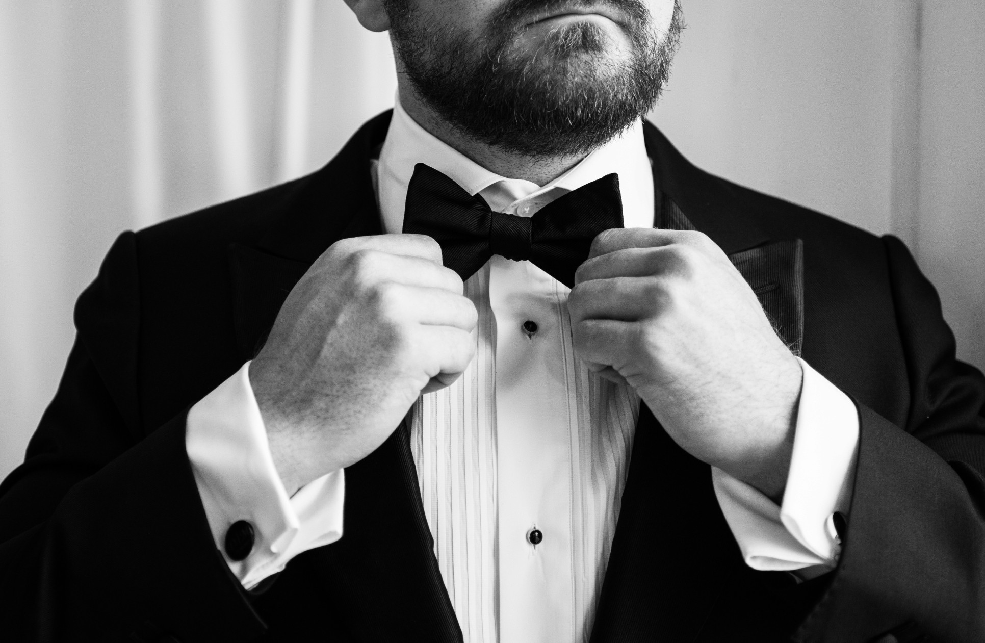 A vibrant bridal bouquet featuring a mix of red, pink, and purple flowers.