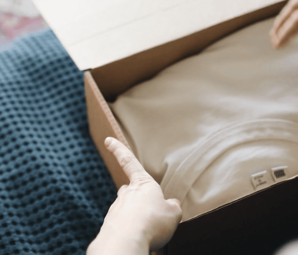 Green field with tire tracks under a clear sky