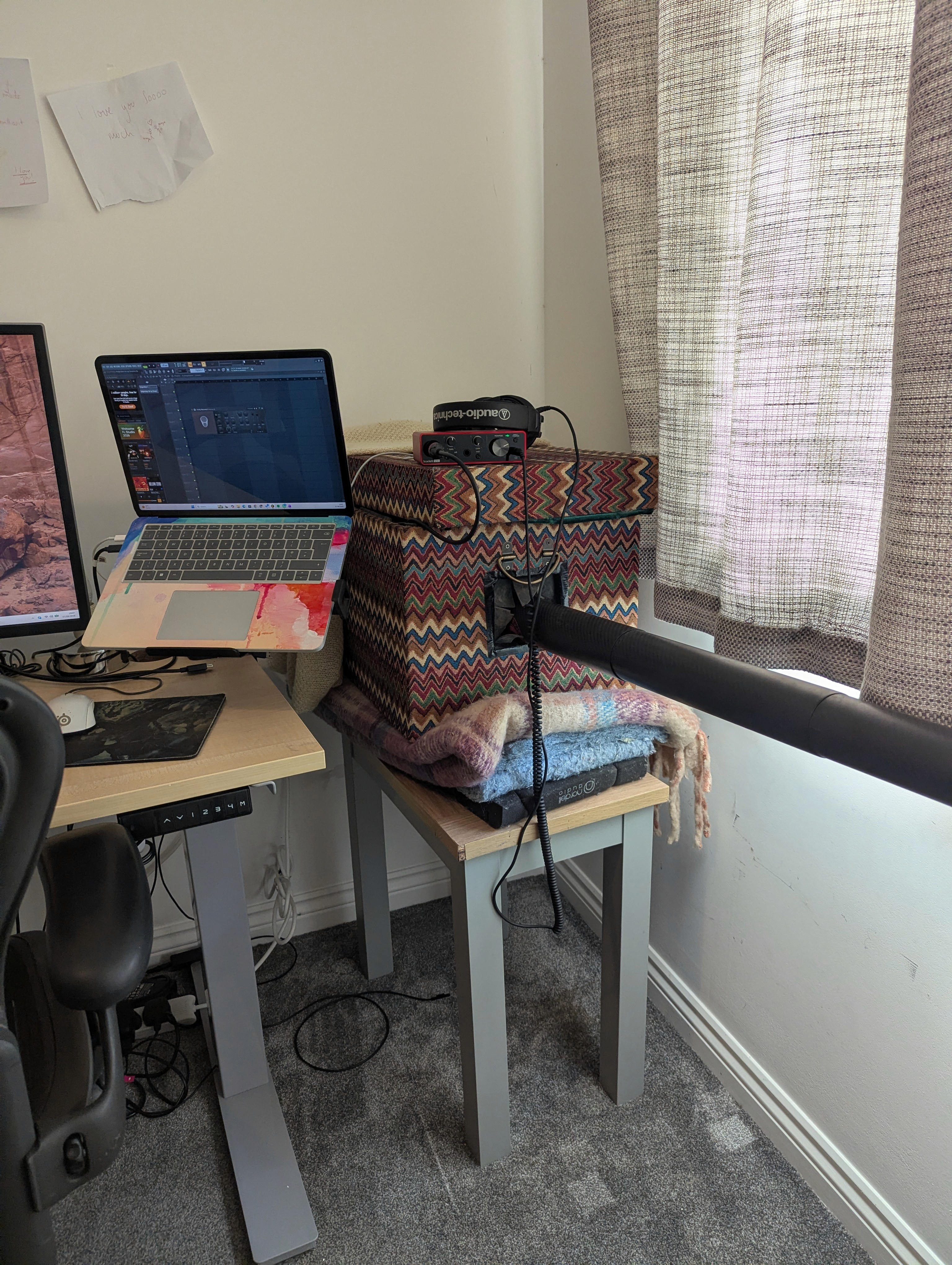 Permanent didgeridoo practice setup beside a desk with the Airdidge connected to the sound-reduction box, audio interface and laptop.