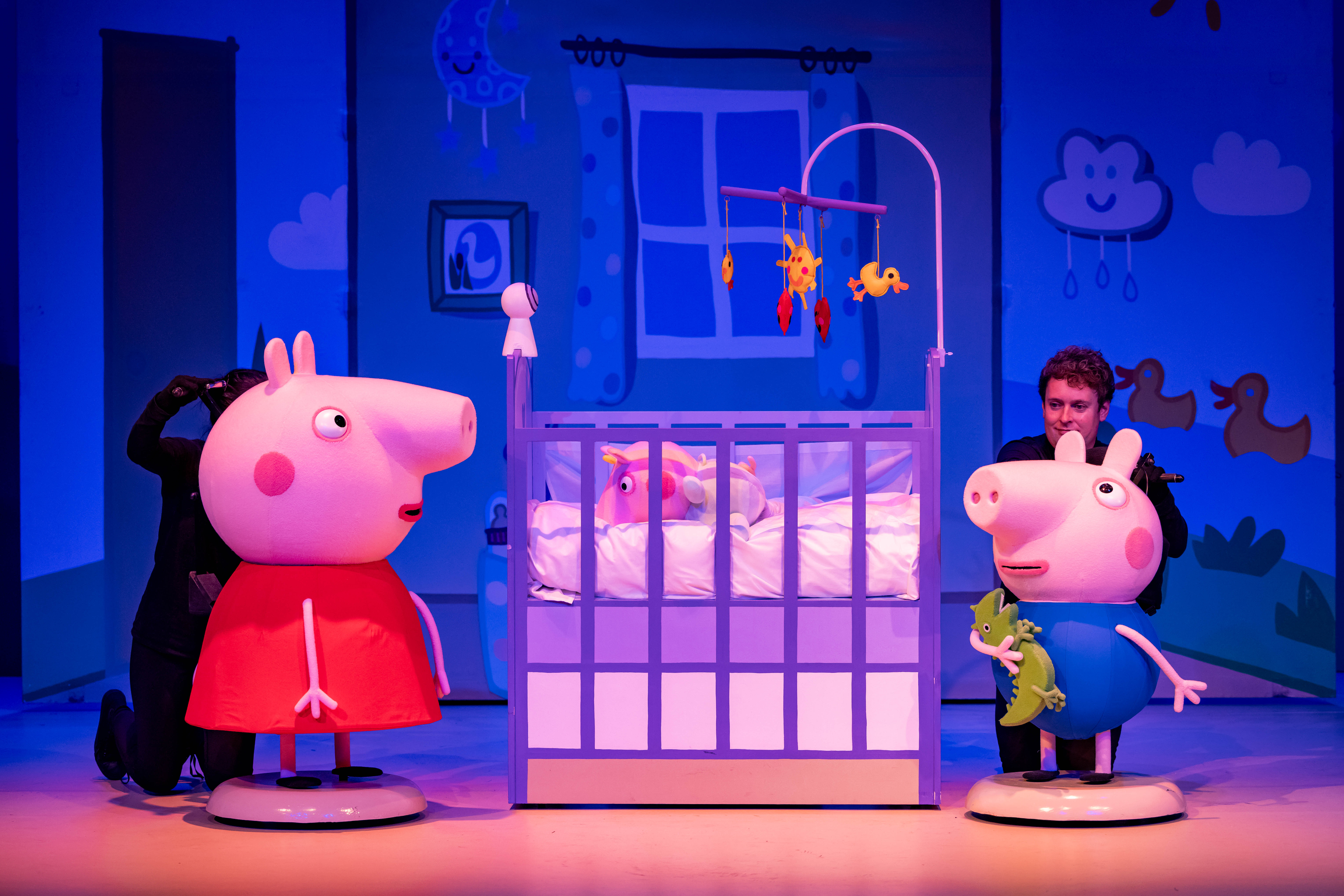 Peppa and George beside a crib in Peppa Pig’s Big Family Show.