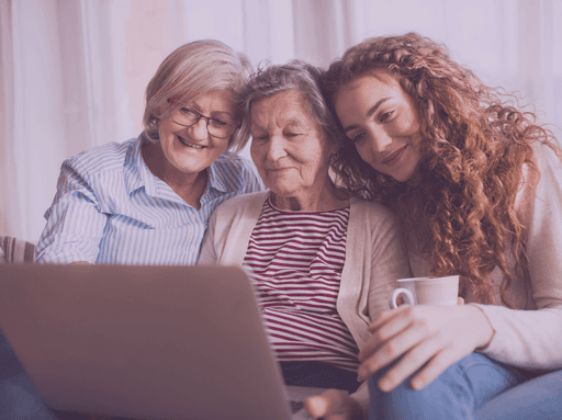 Family using Glimpse to interact with a video of a deceased loved one, smiling and reminiscing together.