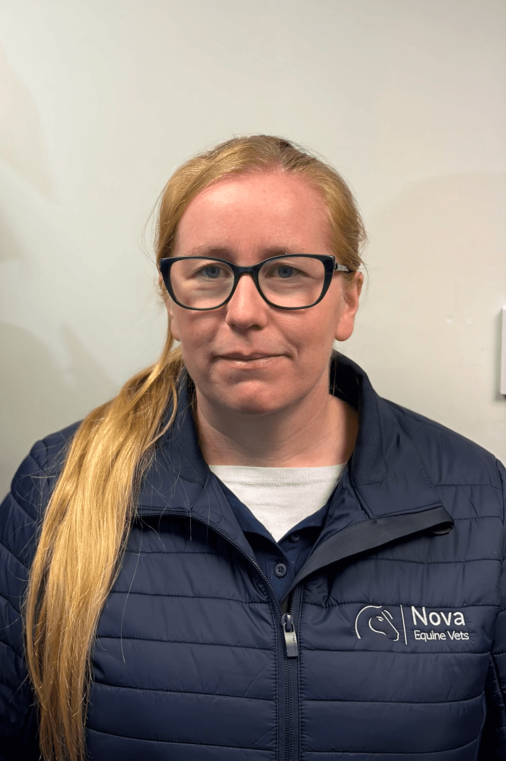 a man in a blue shirt smiling at the camera