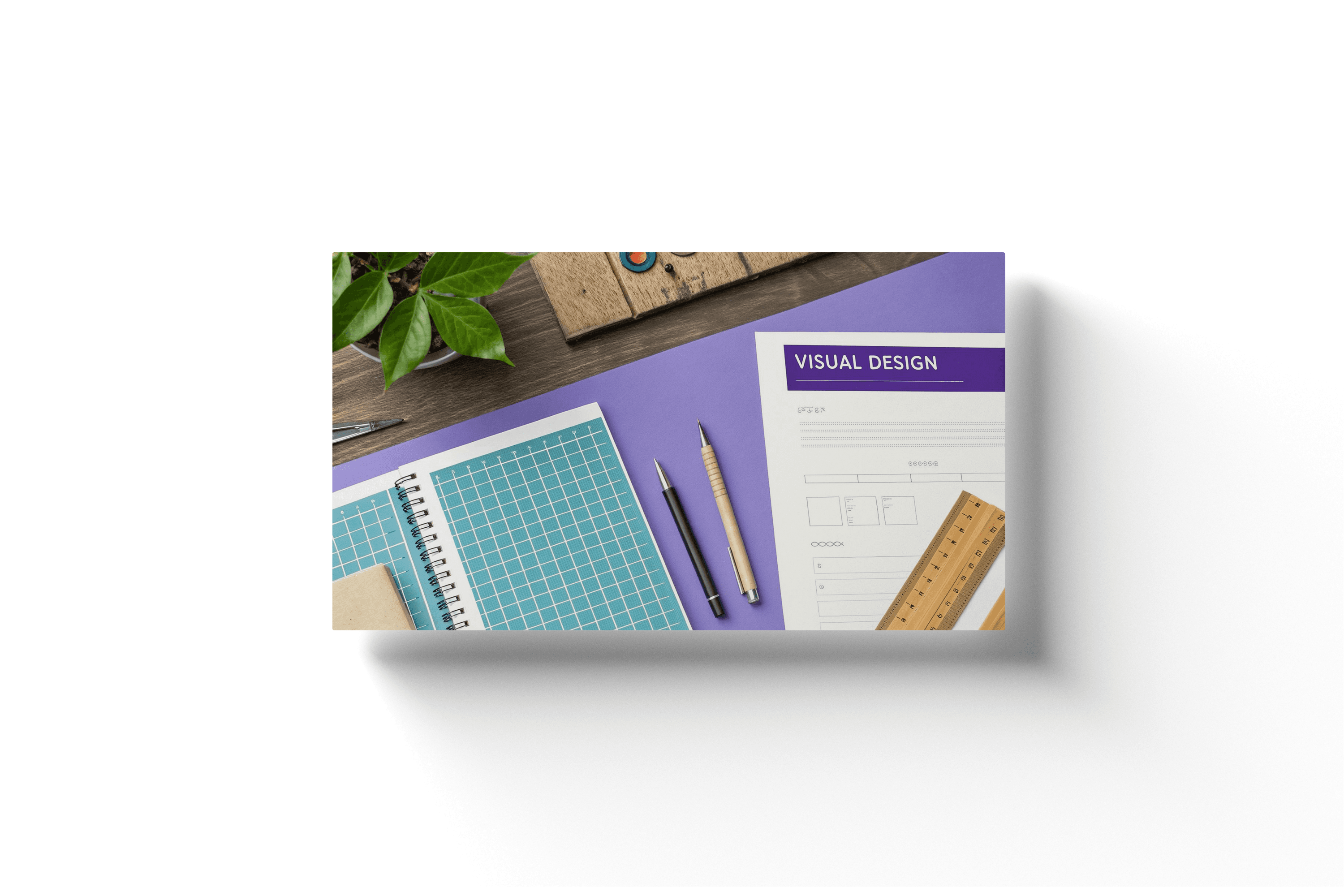 a purple desktop with a paper showing a purple header and text reading 'visual design'