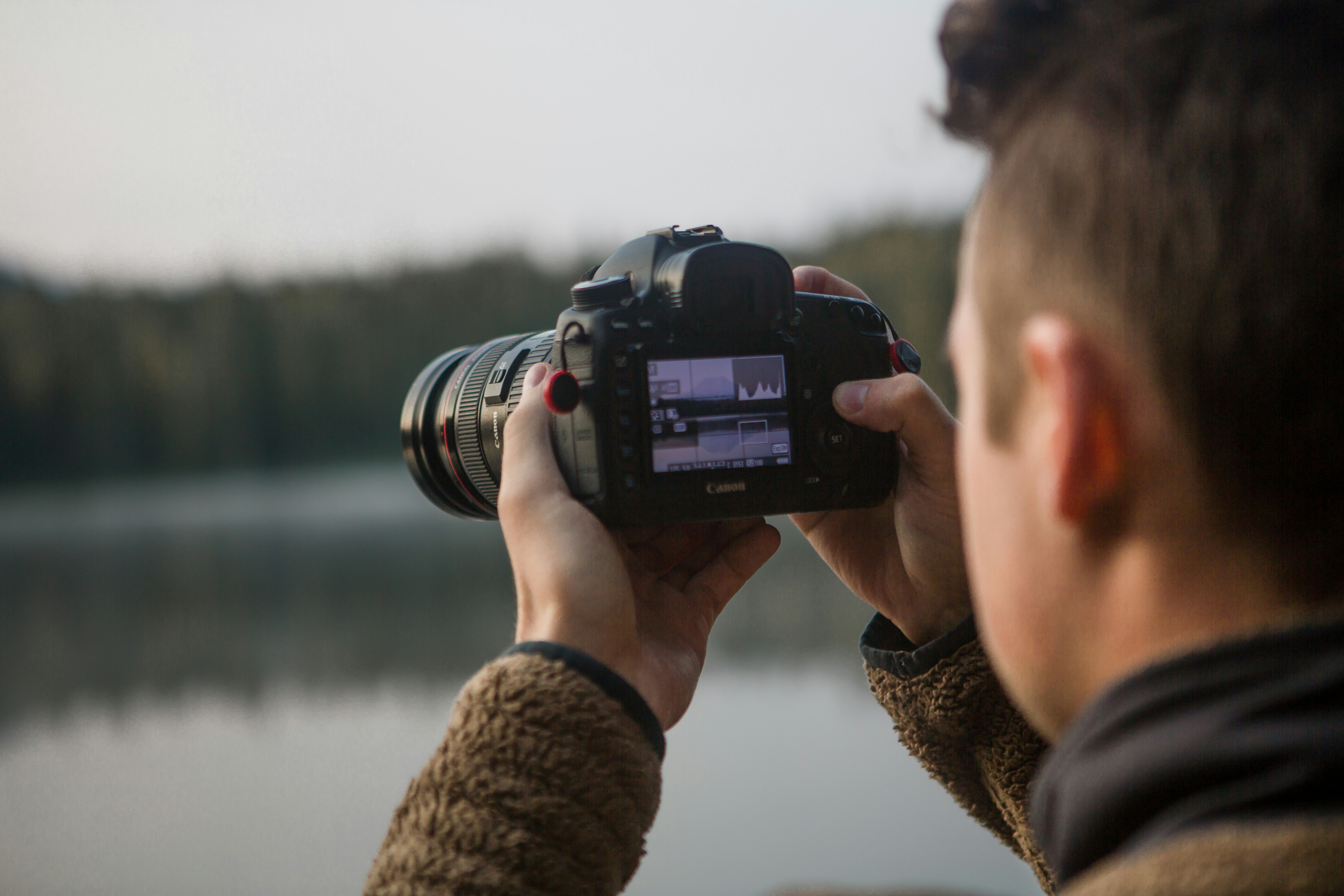 A photographer clicking a professional headshot in an outdoor setting