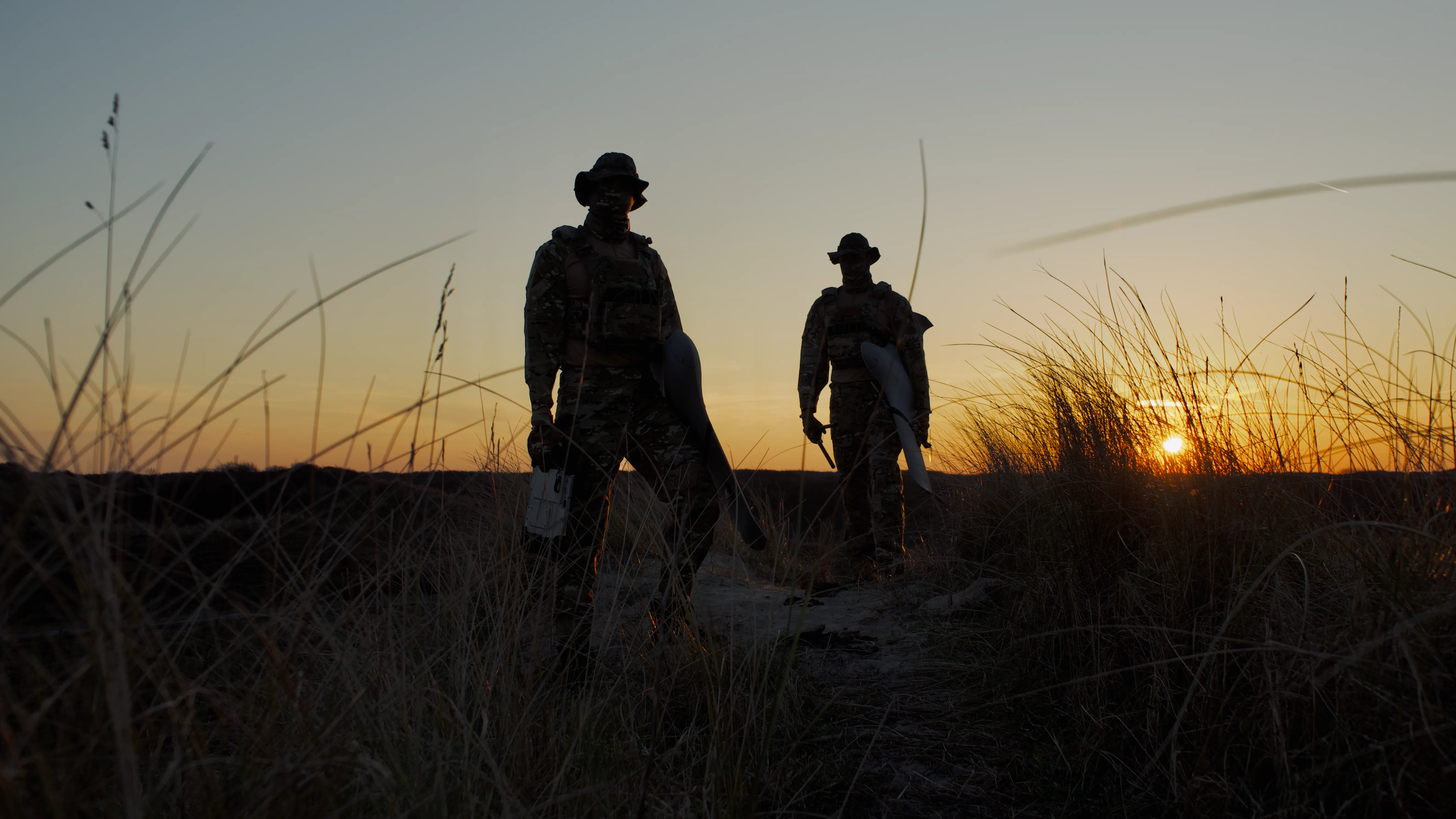 soldiers during the sunset in the dunes