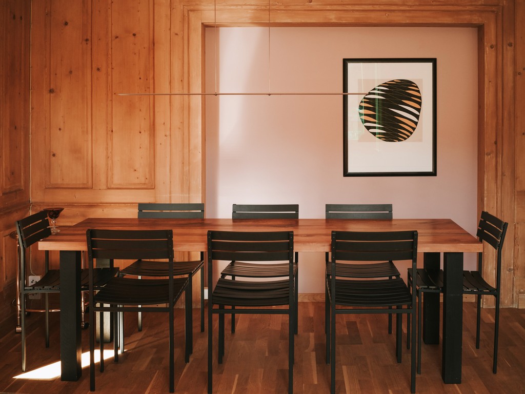 Minimalist room with potted trees and round wall mirrors