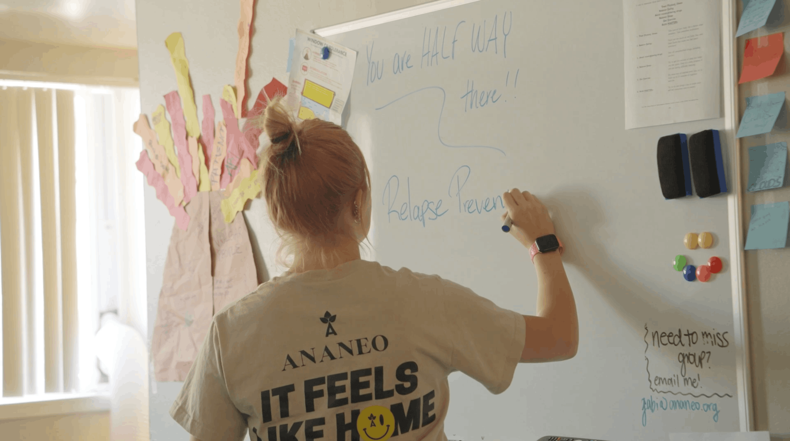 ananeo staff member writing relapse prevention notes on a whiteboard