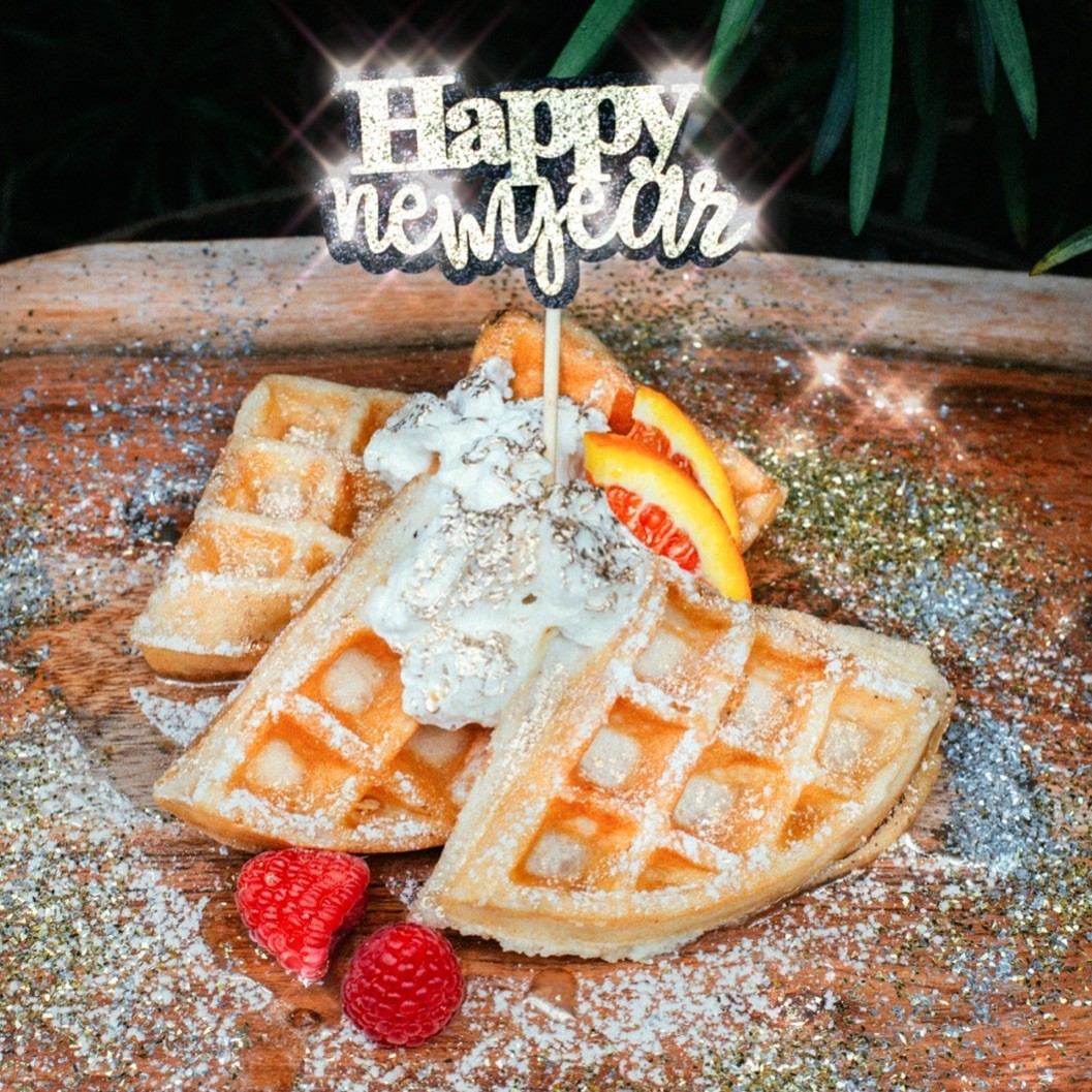 A man holding a cocktail in a dimly lit bar