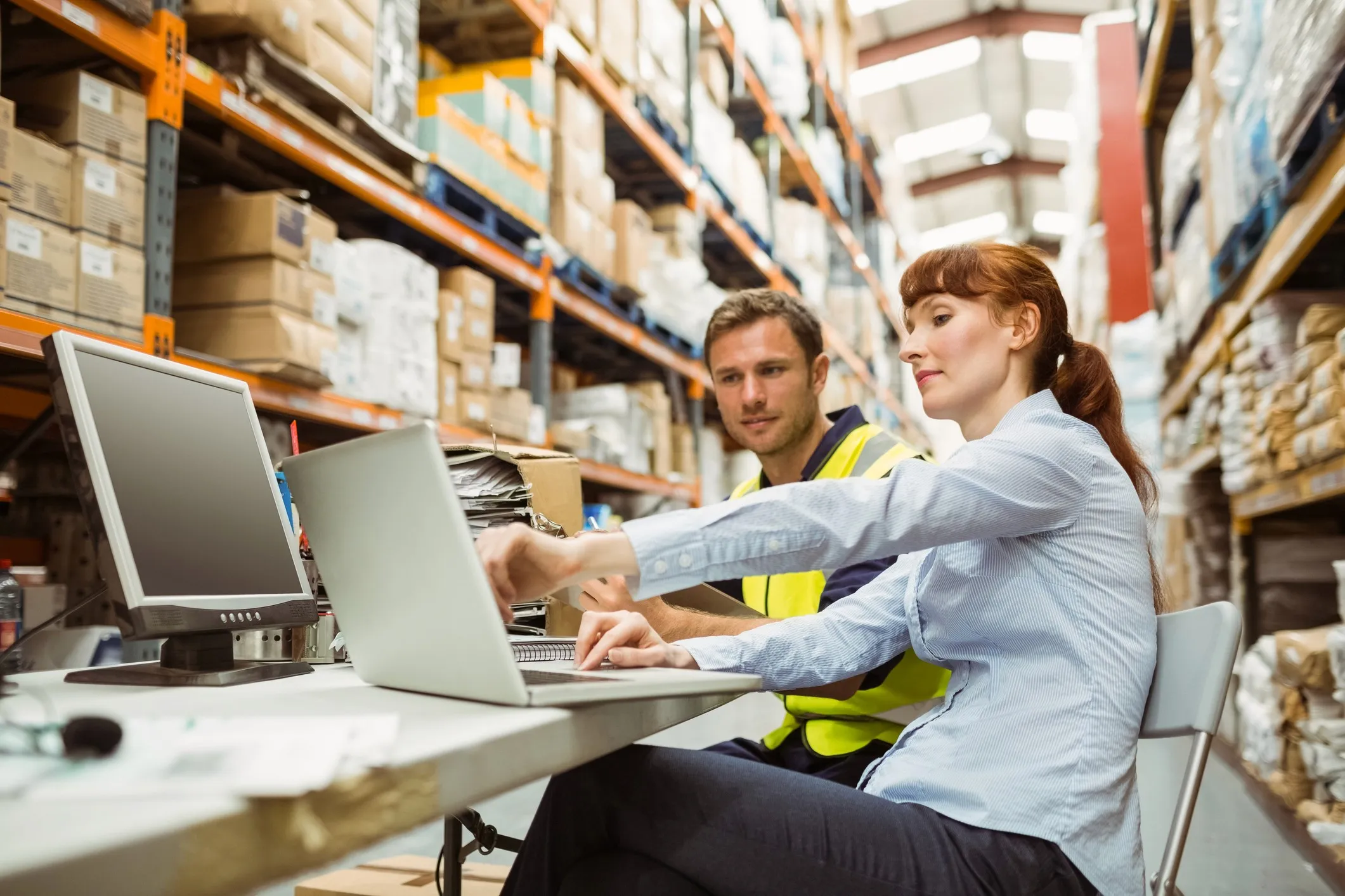 Industrial engineers building engineered labor standards for warehouse operations using a labor management system to define productivity benchmarks and optimize workforce performance.
