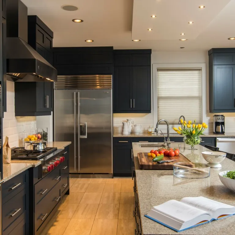 Image of Luxury kitchen design with black cabinets, stainless steel appliances, and layout design by KHD Homes.