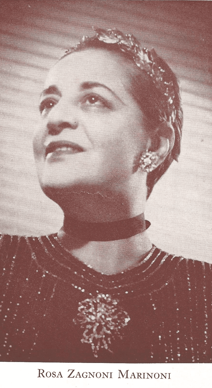 vintage photograph of Rosa Zagnoni Marinoni in an elegant sequined dress with a large jeweled brooch and earrings. She gazes confidently above, chin lifted
