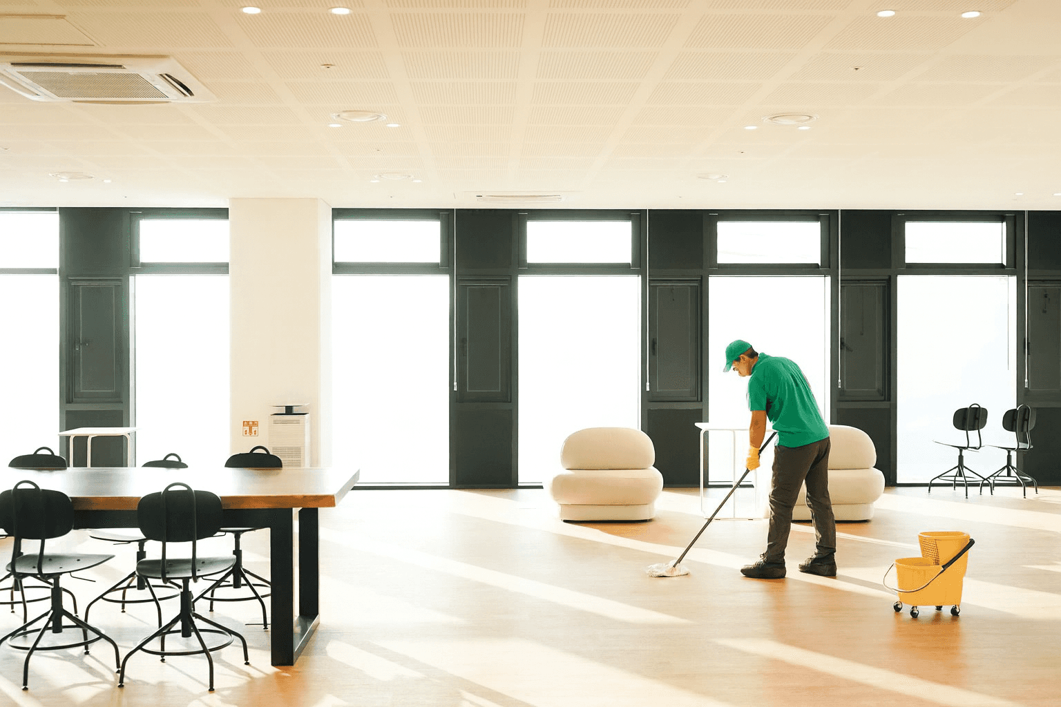 woman in blue tank top standing beside white wall