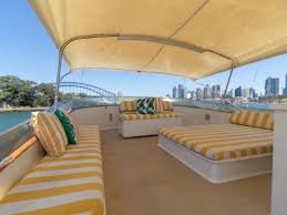 John Oxley yacht: Upper deck, striped seating city skyline view