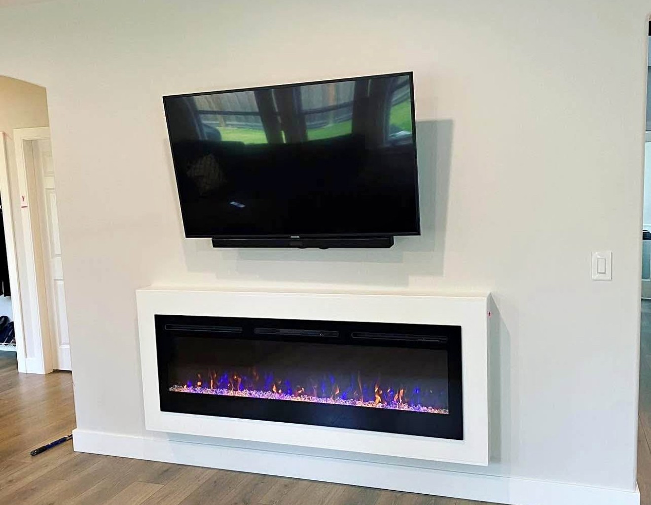 70-inch TV mounted using a over fireplace setup in a residential home in Dallas, with clean wiring and a modern look.
