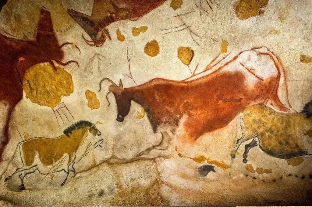 Lascaux II cave painting replica showing aurochs and horses in ochre and red pigment.