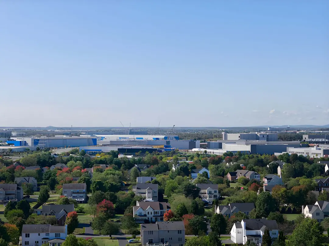 An aerial landscape of residential neighborhoods and commercial developments, serviced by a trusted plumber in Ashburn, VA.