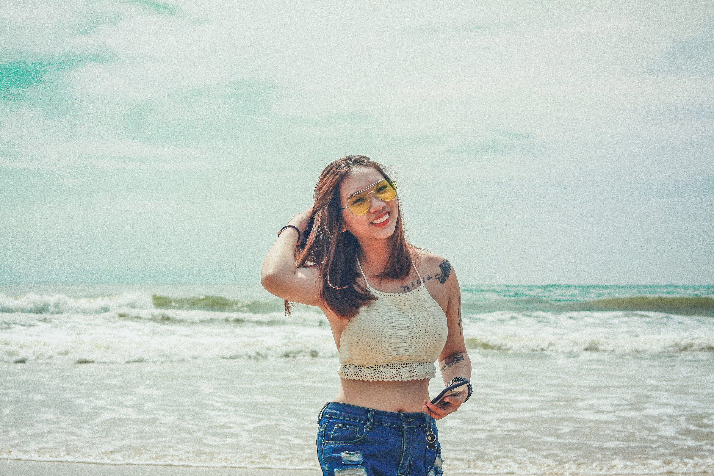 woman walking down a beach - Preppy Definition