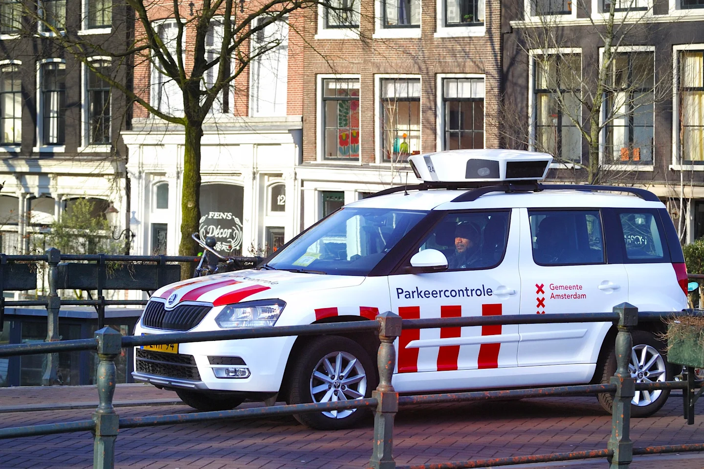 EGIS — Amsterdam municipality parking enforcement vehicle parked along a city canal — Soda Studio case study