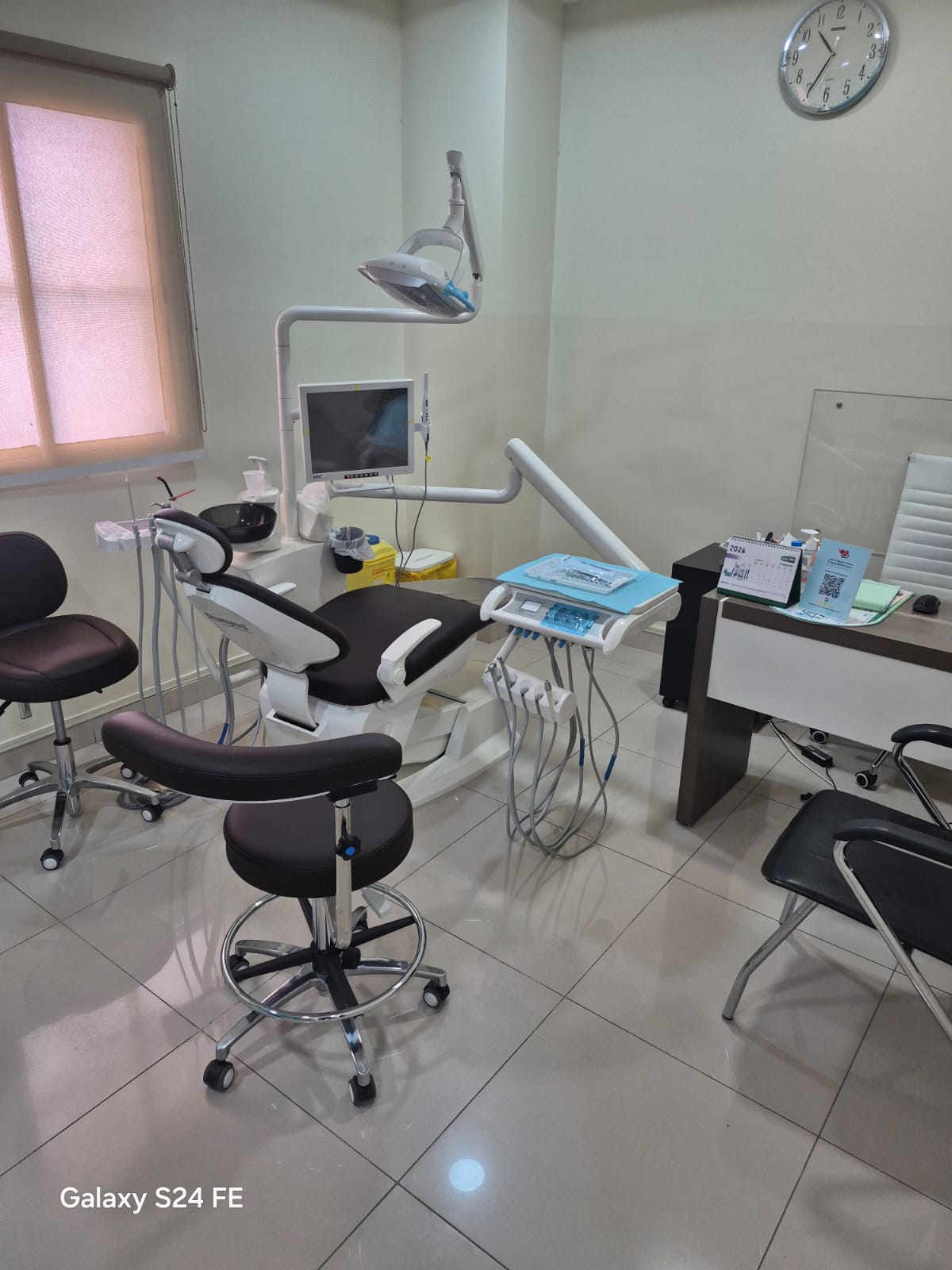 a dental room with a desk and chairs