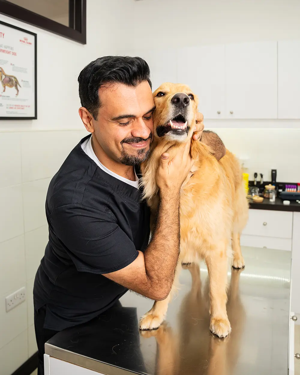 A photo of vet dermatology specialist Dr Soheyl Simaei with a Golden Retriever dog.