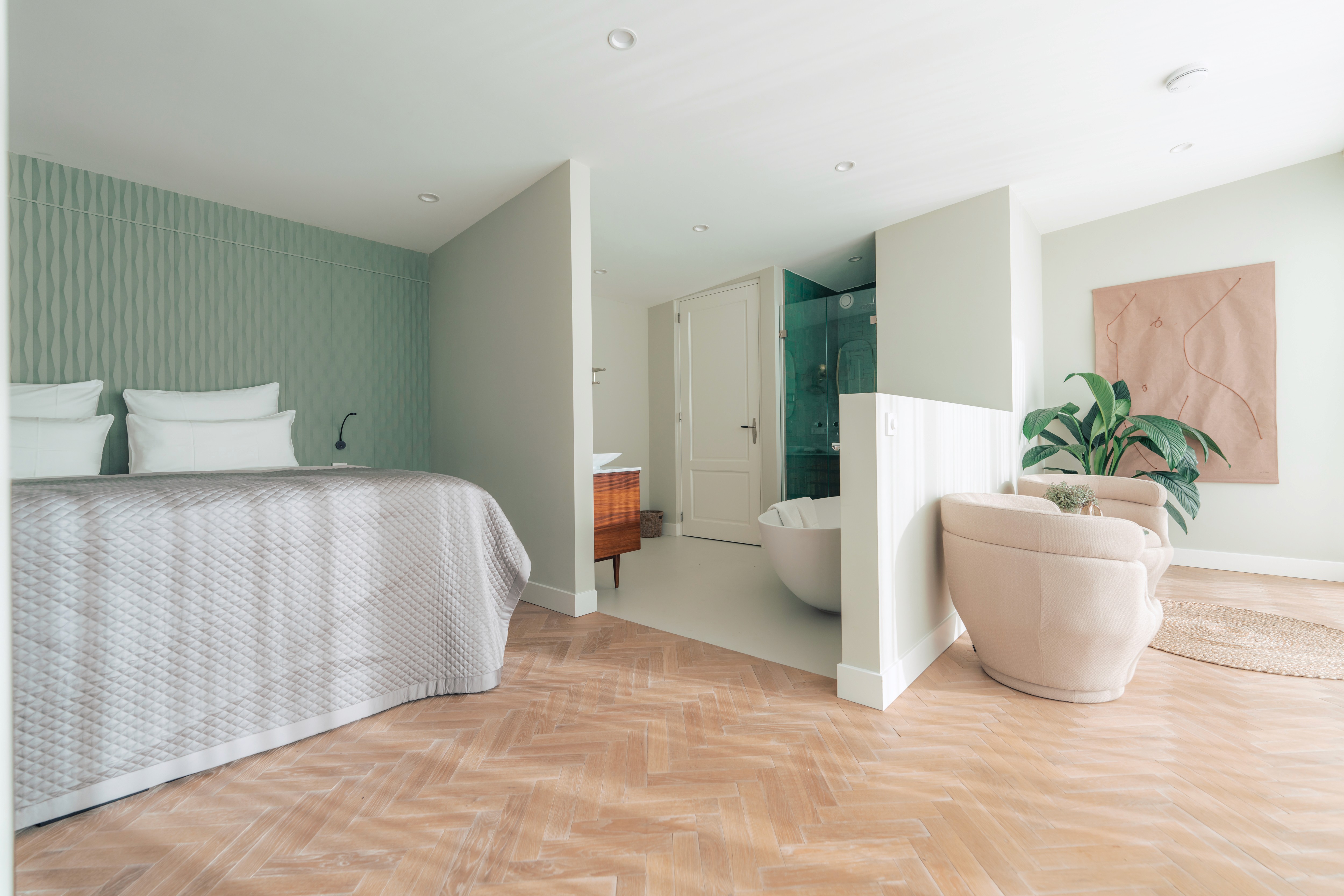 lounge room with large contemporary lamp, cozy sofa and blue toned painting of Venice