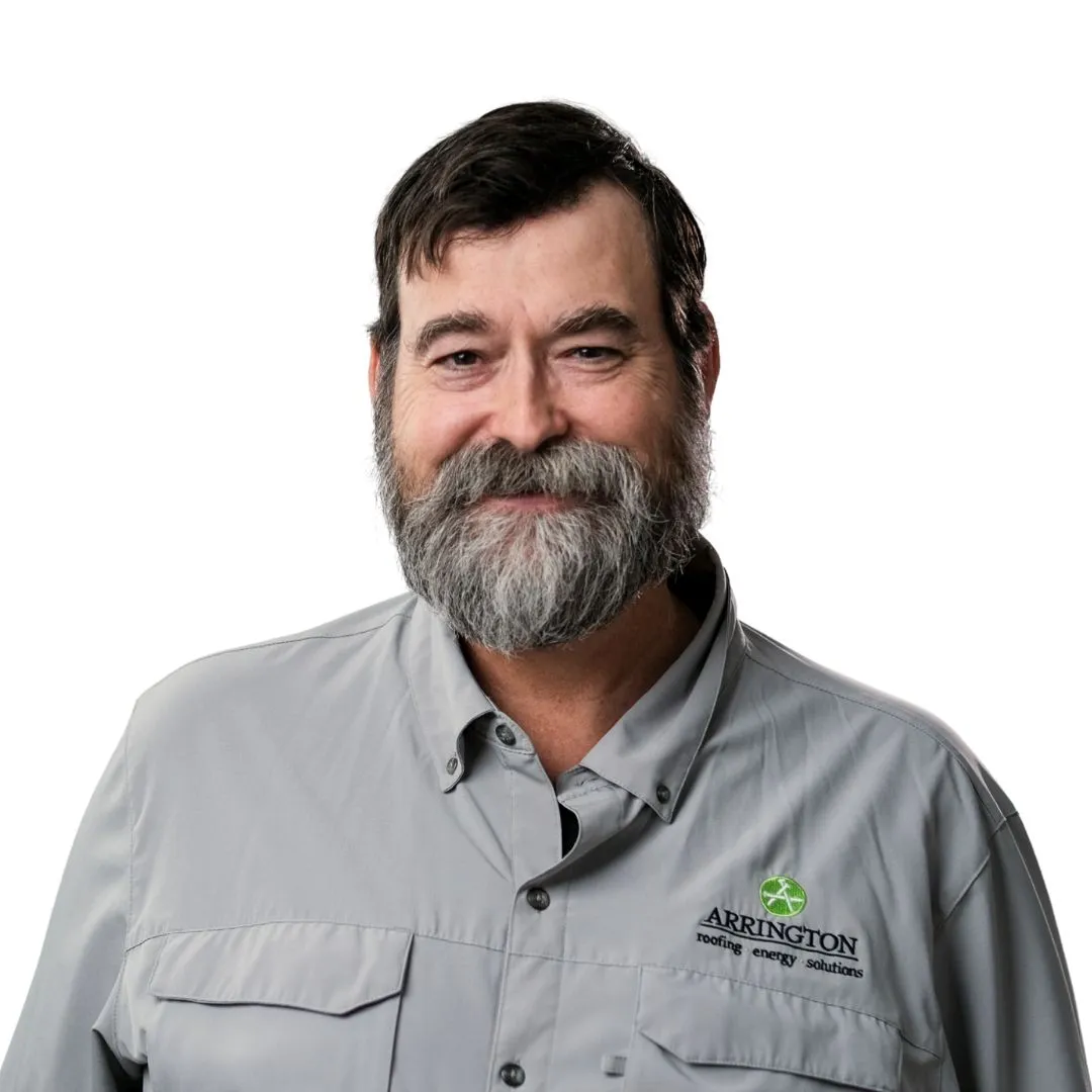 Man with beard smiles wearing a gray Akrington heating & energy solutions shirt