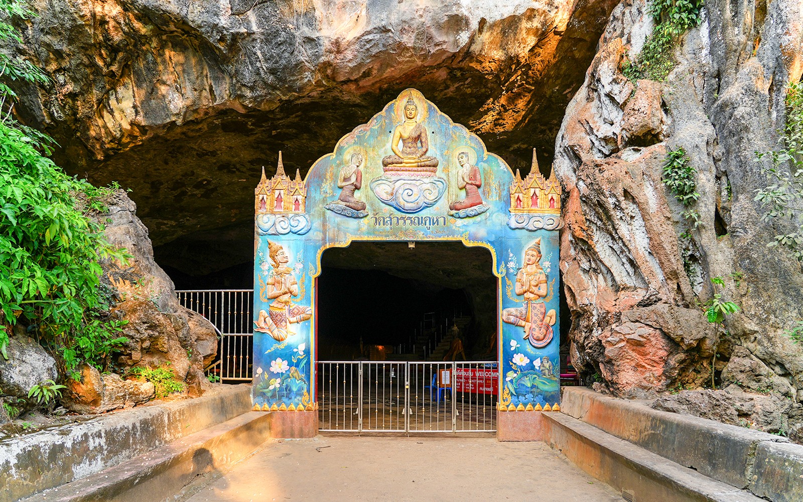 ทางเข้าไปในวัดถ้ำตกแต่งในภูเก็ต ซึ่งมีงานศิลปะทางศาสนาที่มีสีสันสดใส