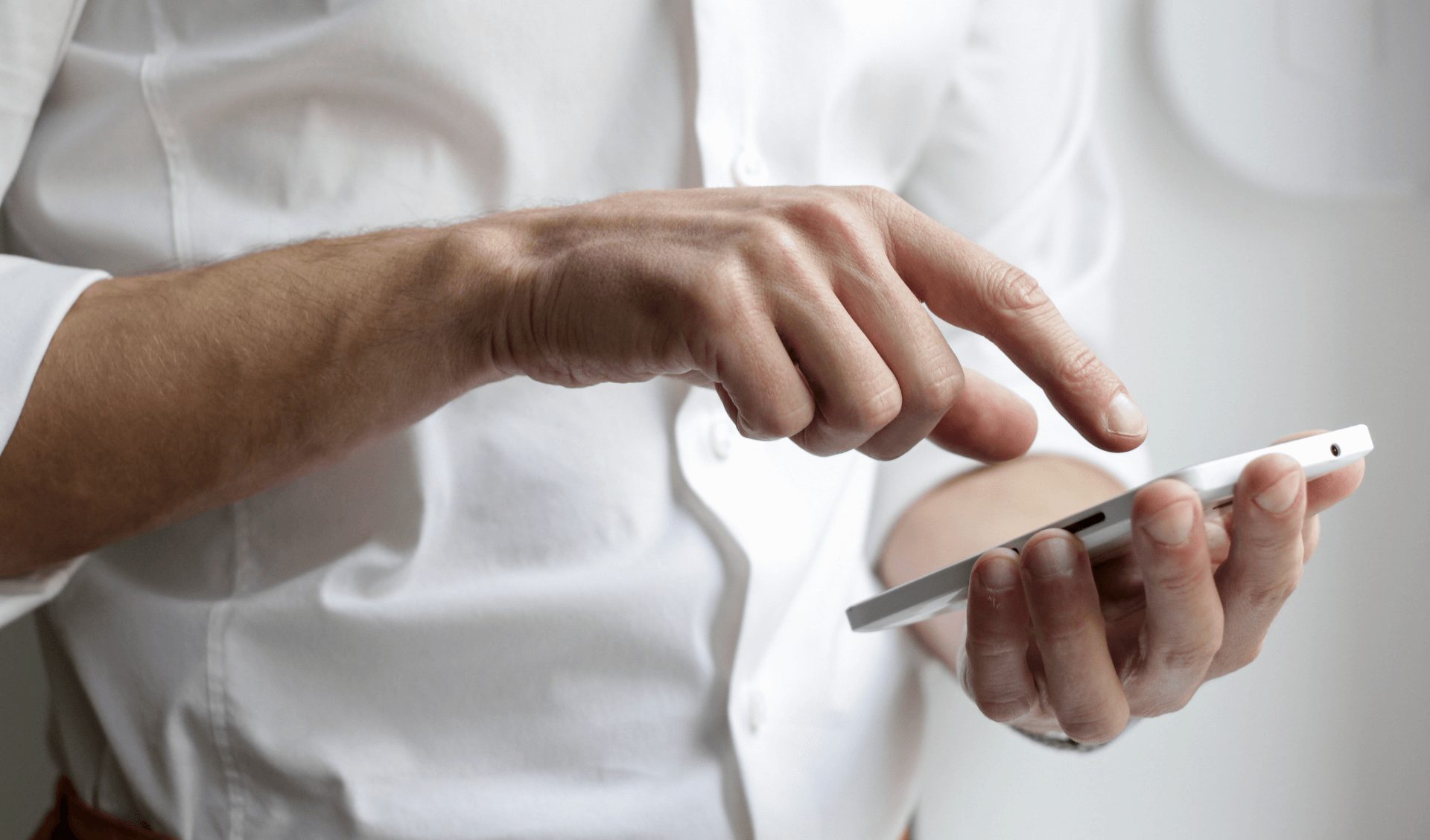 Man pressing the screen on his phone