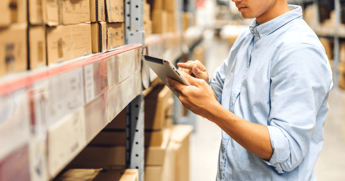 Warehouse worker scanning boxing shipment, shows a stage in the order to cash process.