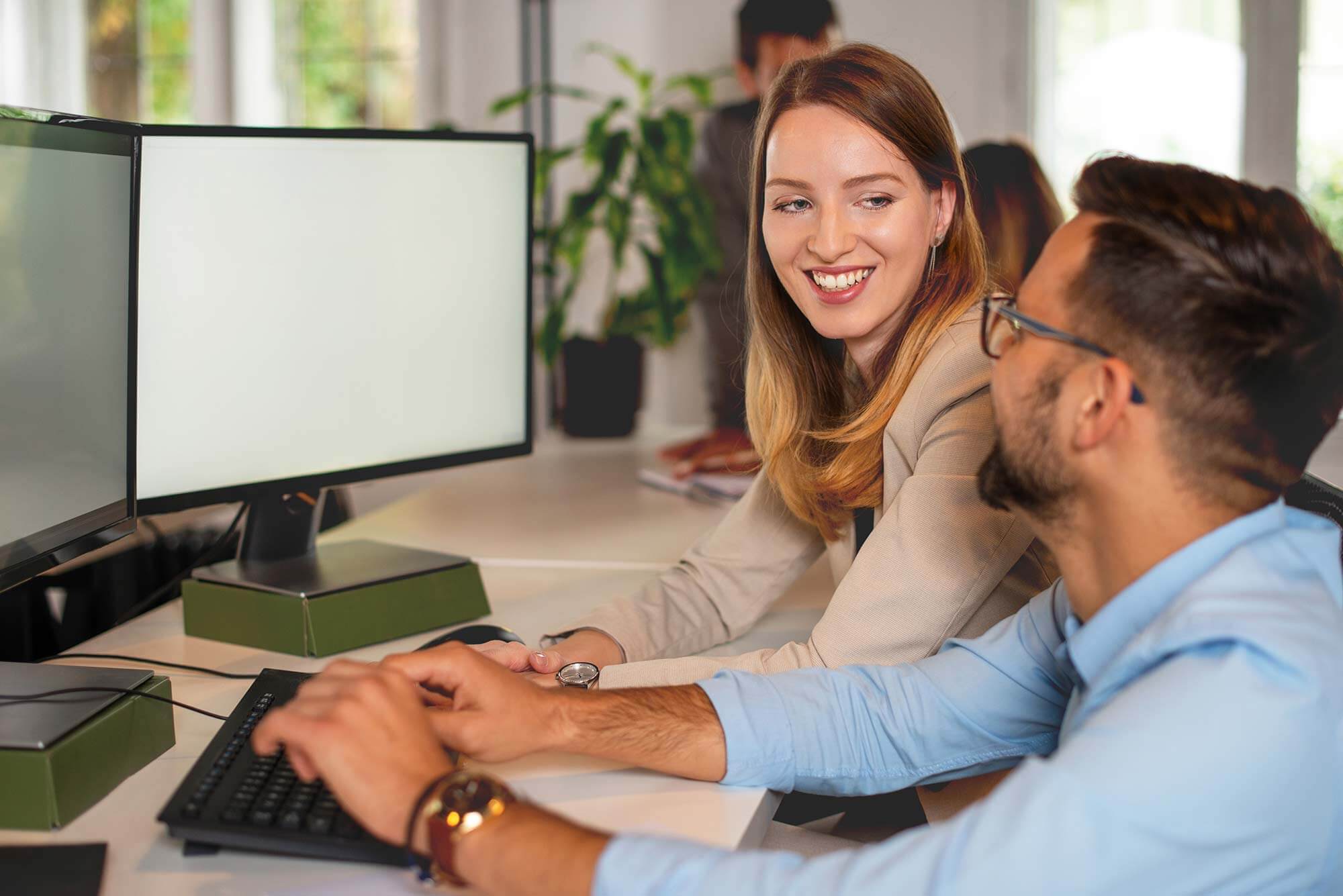 Man and woman looking at a screen