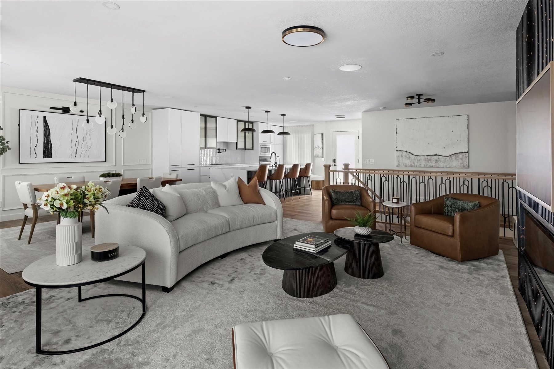 Strathcona open living area after: curved sofa, sculptural tables and the new dining room and kitchen beyond