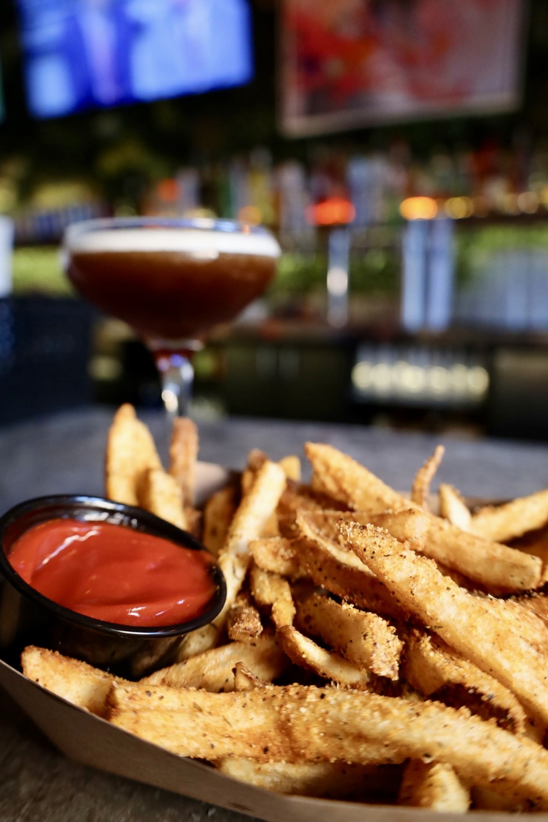 Dark and moody shot of a cocktail sitting on a bar