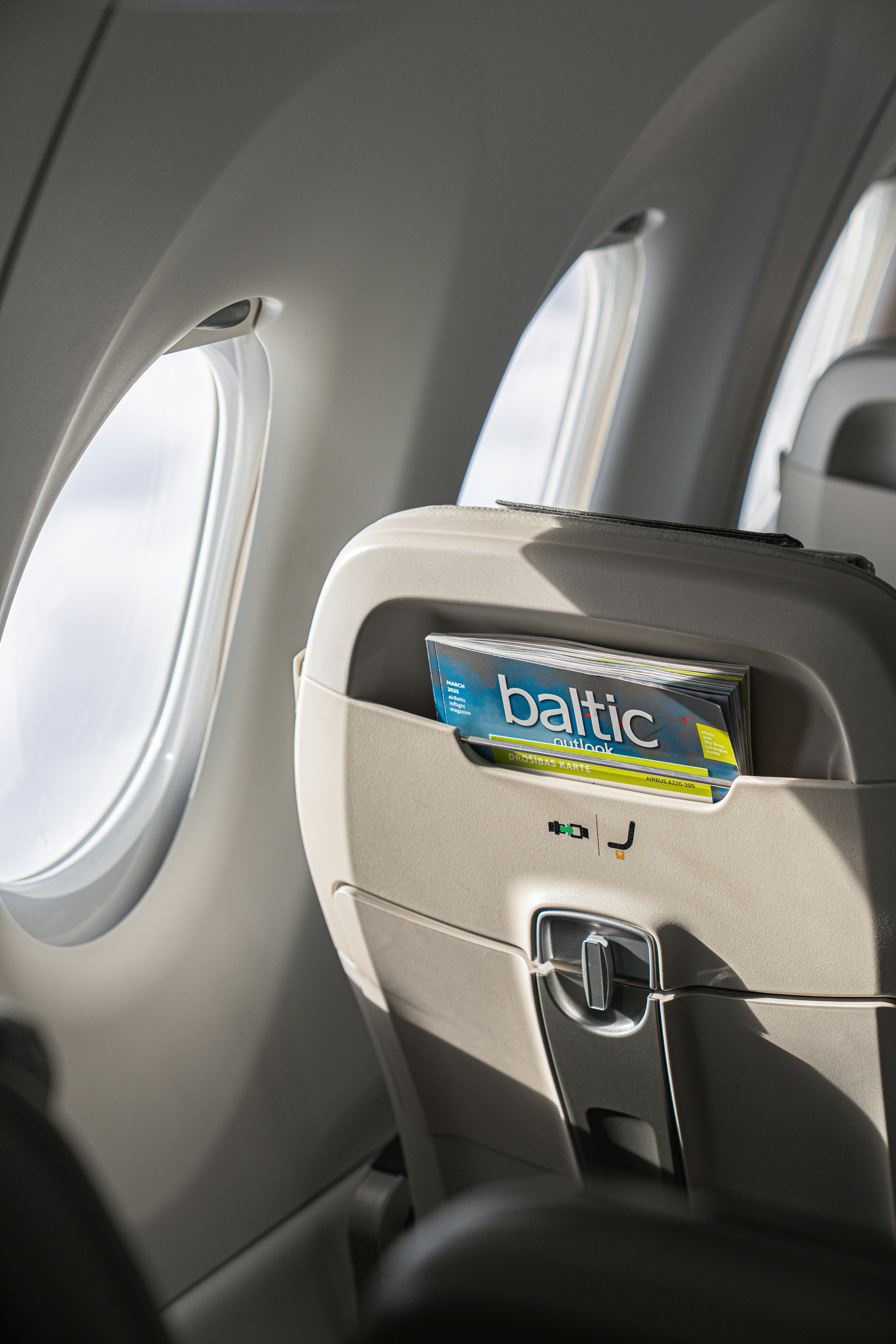 Seat pocket with baltic magazine on airplane